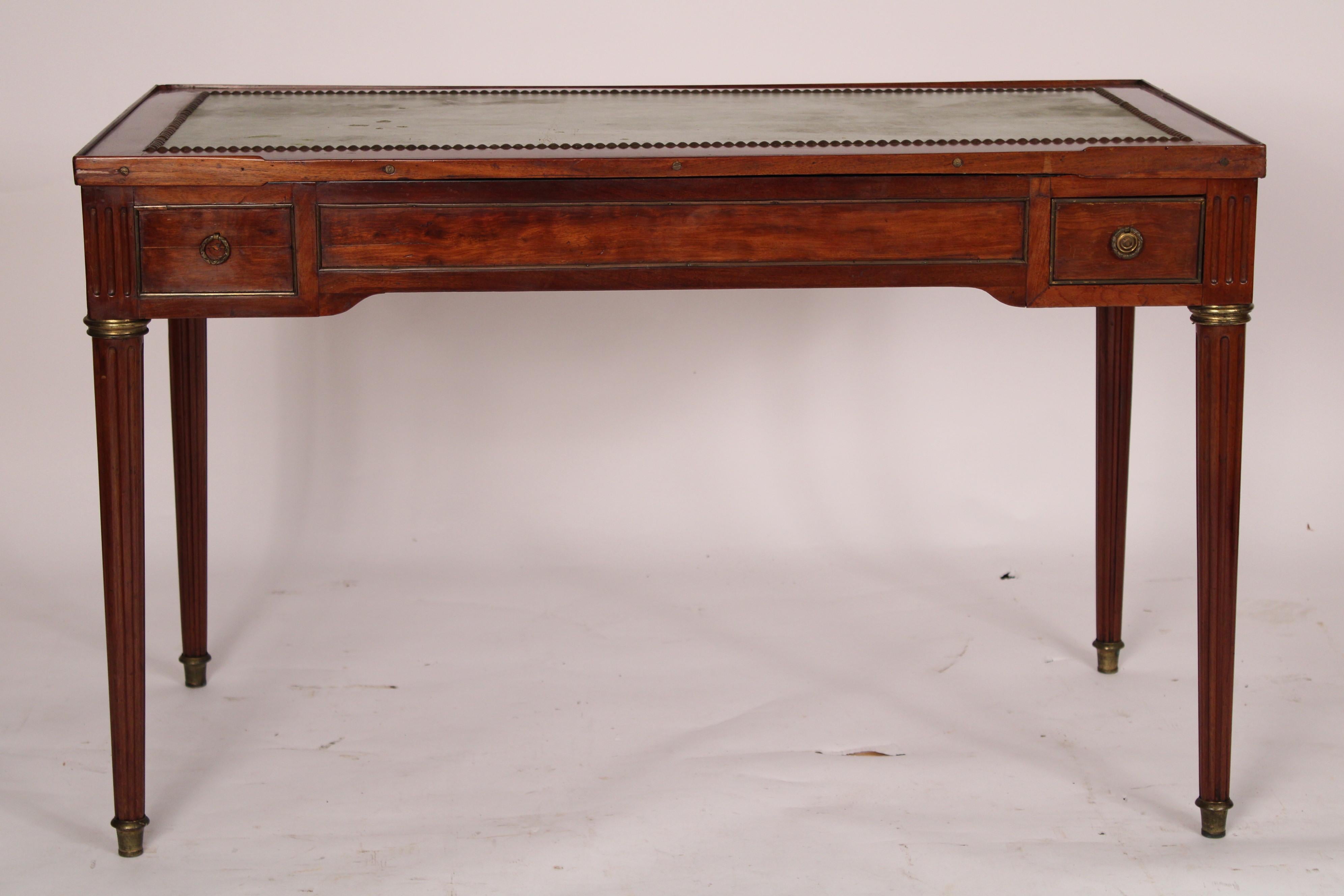 Antique Louis XVI style mahogany brass mounted tric trac / writing table, 19th century. Removeable mahogany top inset with faux leather, frieze with brass mounted drawers, drawer on the right side pulls out the center and left drawer fronts are