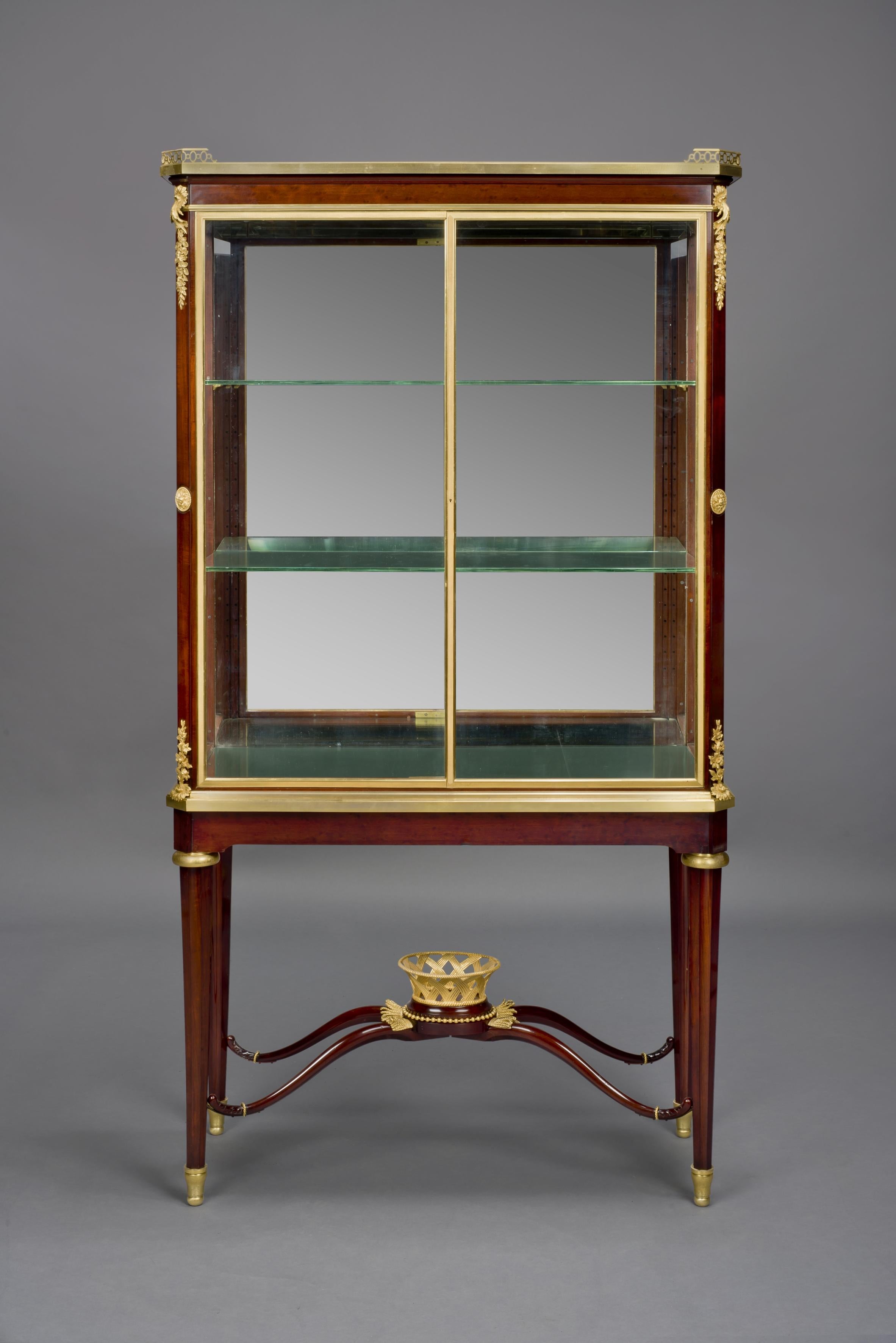 A fine Louis XVI style gilt bronze mounted mahogany vitrine, by Alfred Louis Beurdeley.

French, circa 1880.

Stamped to the carcass ‘A. Beurdeley à Paris’.

This fine mahogany vitrine has a gilt bronze galleried top above a glazed square