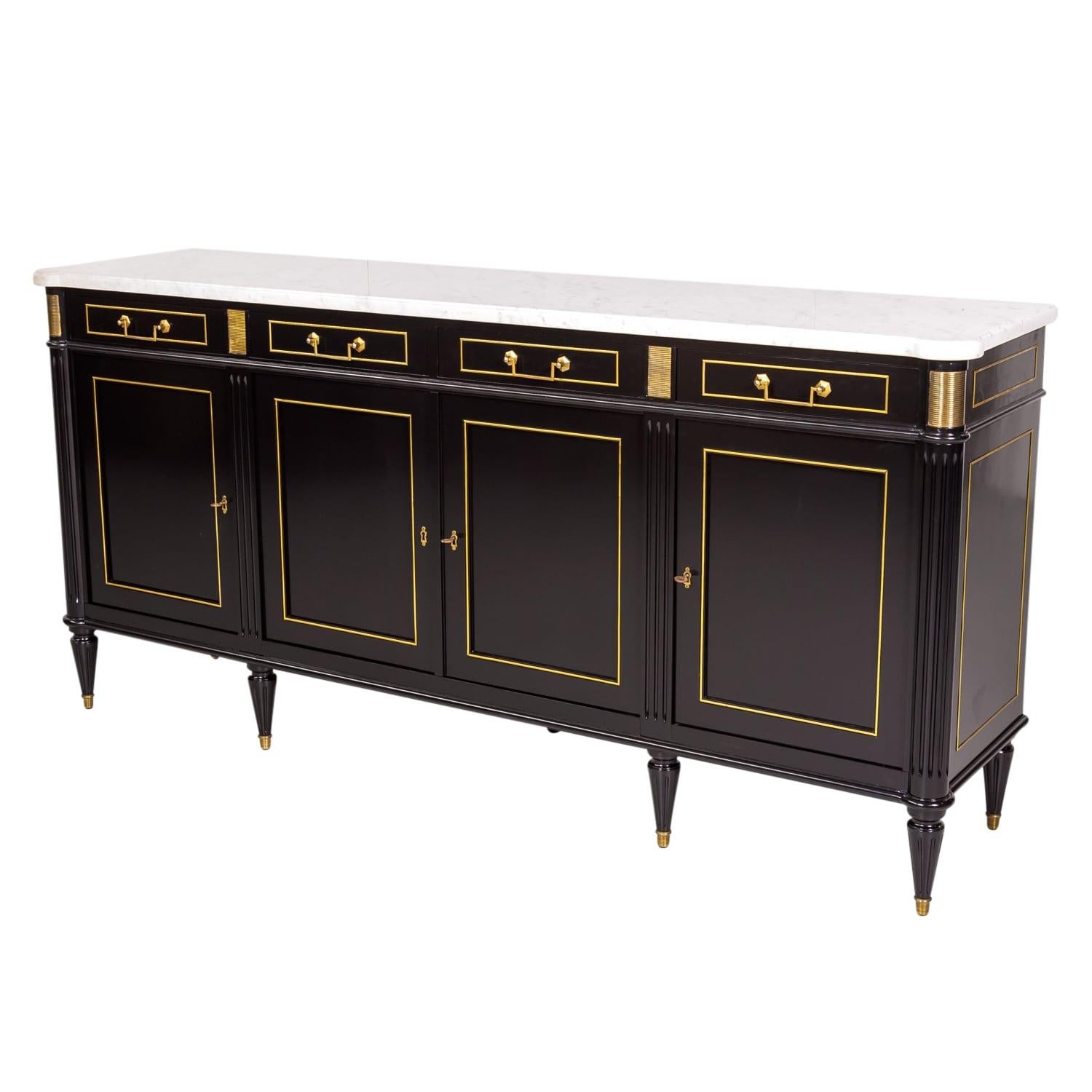 Mid-20th century mahogany Louis XVI style four-drawer, four-door enfilade buffet, circa 1940s. Having an ebonized semi-gloss lacquered finish with original polished Carrara marble top and original brass drop bail handles and trim, this beautiful