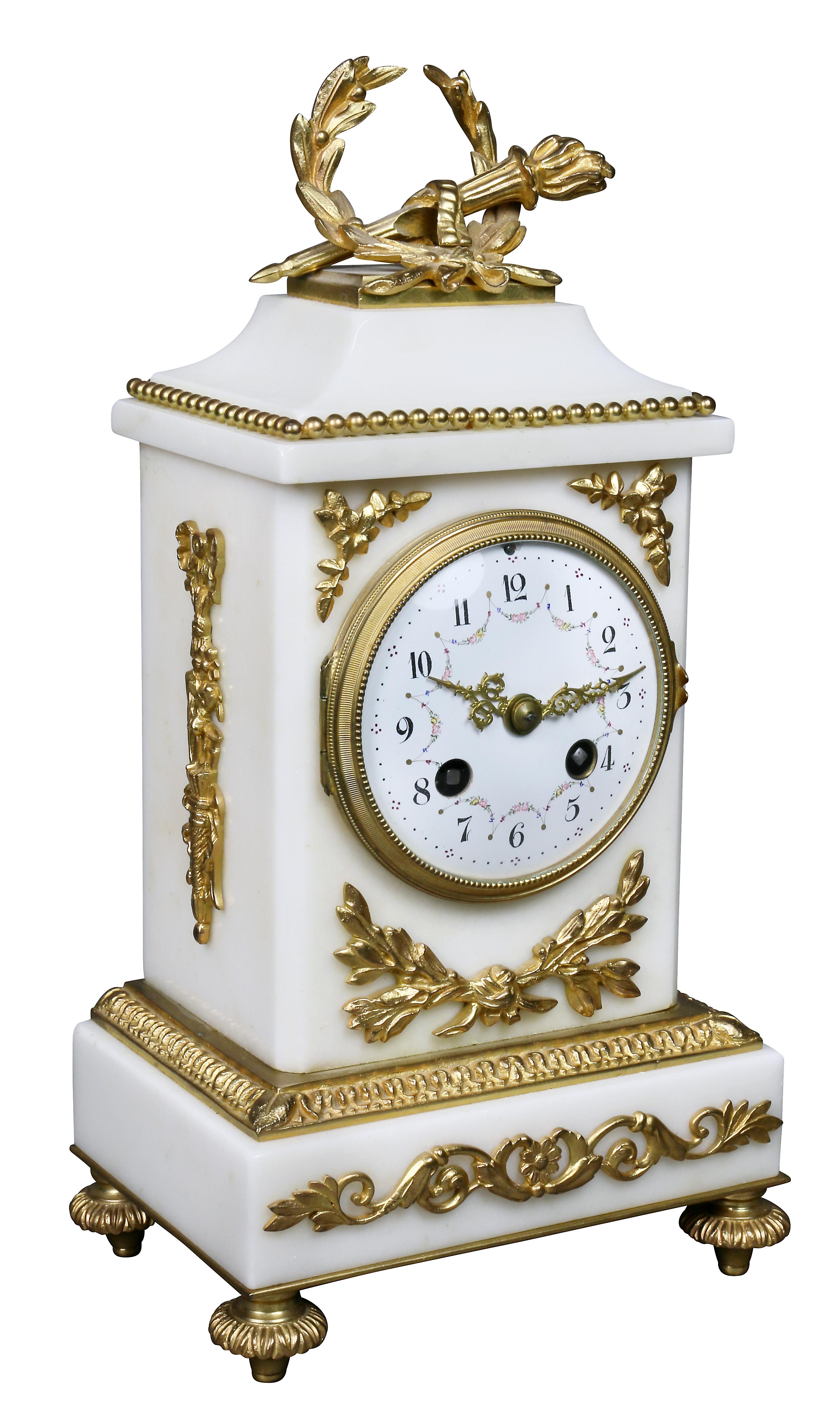 The clock with laurel wreath and torch finial over a clock set in a rectangular case, bronze feet. Together with a pair of two light candelabra.