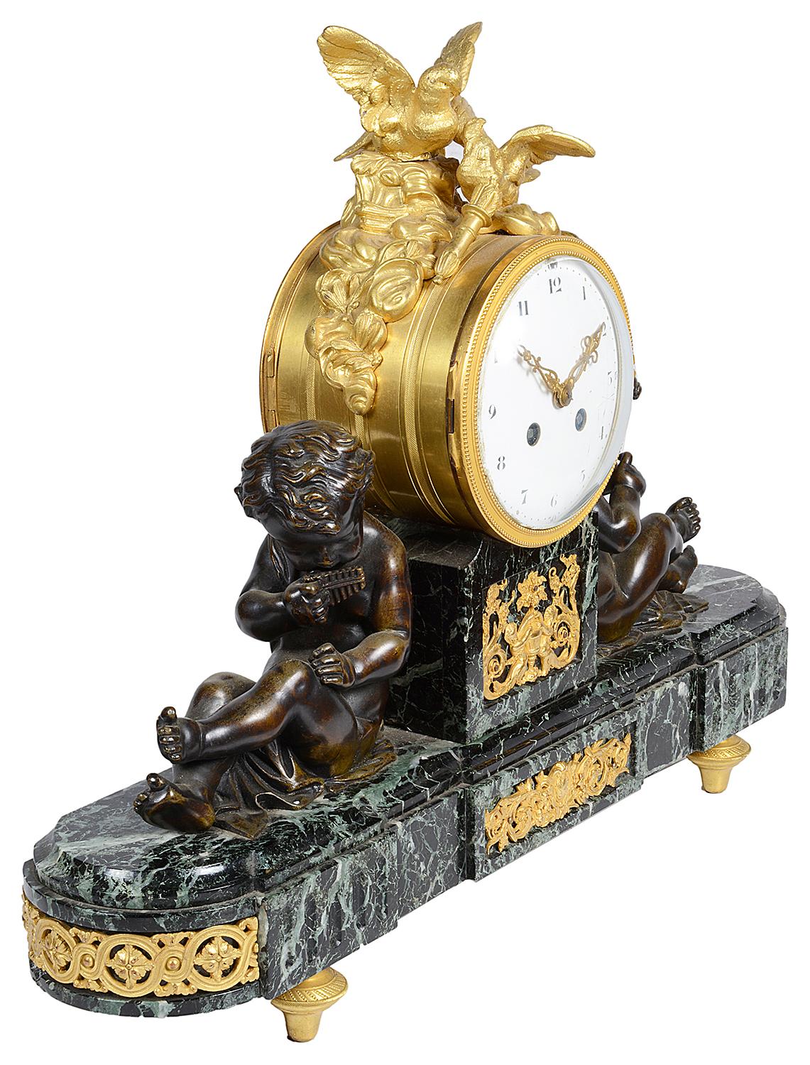 A good quality late 19th century French Louis XVI style mantel clock, having a pair of bronze putti either side of the eight day duration, chiming clock, mounted by a pair of gilded ormolu Doves, raised on a green marble base and ormolu feet.