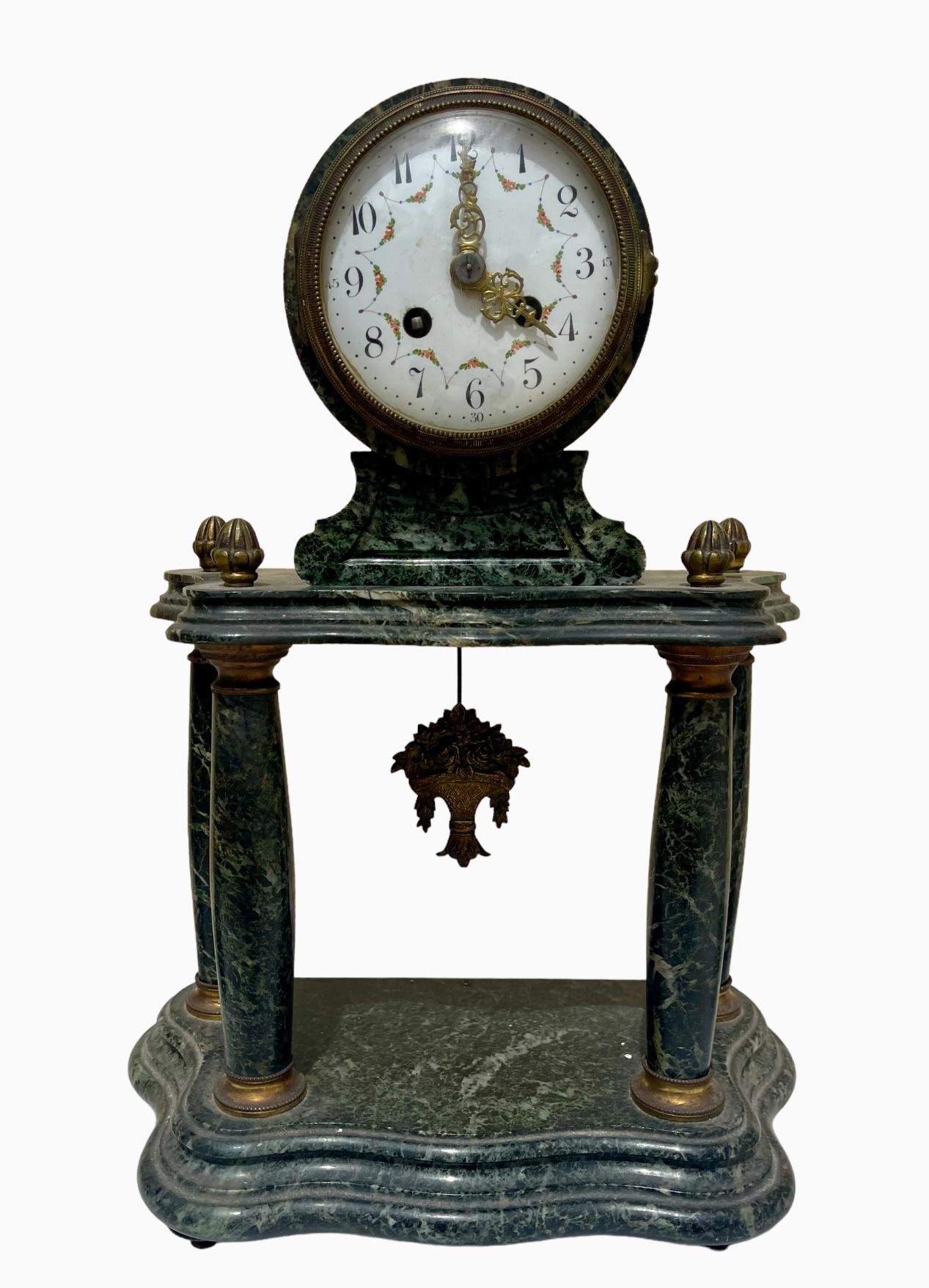 Louis XVI style sea green marble and bronze fireplace surround. Consisting of a 4-column clock and 2 pots. Mechanism with pendulum in working order but needs to be revised.

Dimensions
Clock - Height 44cm x Width 31.5cm x depth 17cm
Vases - height