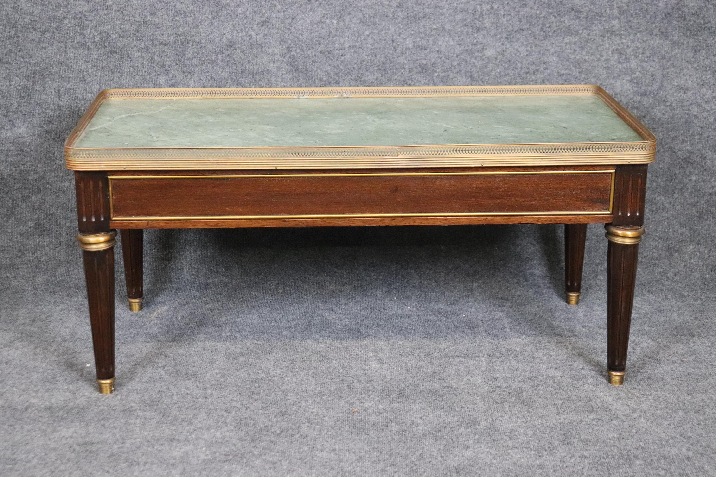 Dimensions: Height: 18 1/4 in Width: 39 3/4 in Depth: 20 in 


This vintage Louis XVI style marble top coffee table, attributed to Maison Jansen, coffee table is of the highest quality! Maison Jansen made some of the world's most chic furniture and