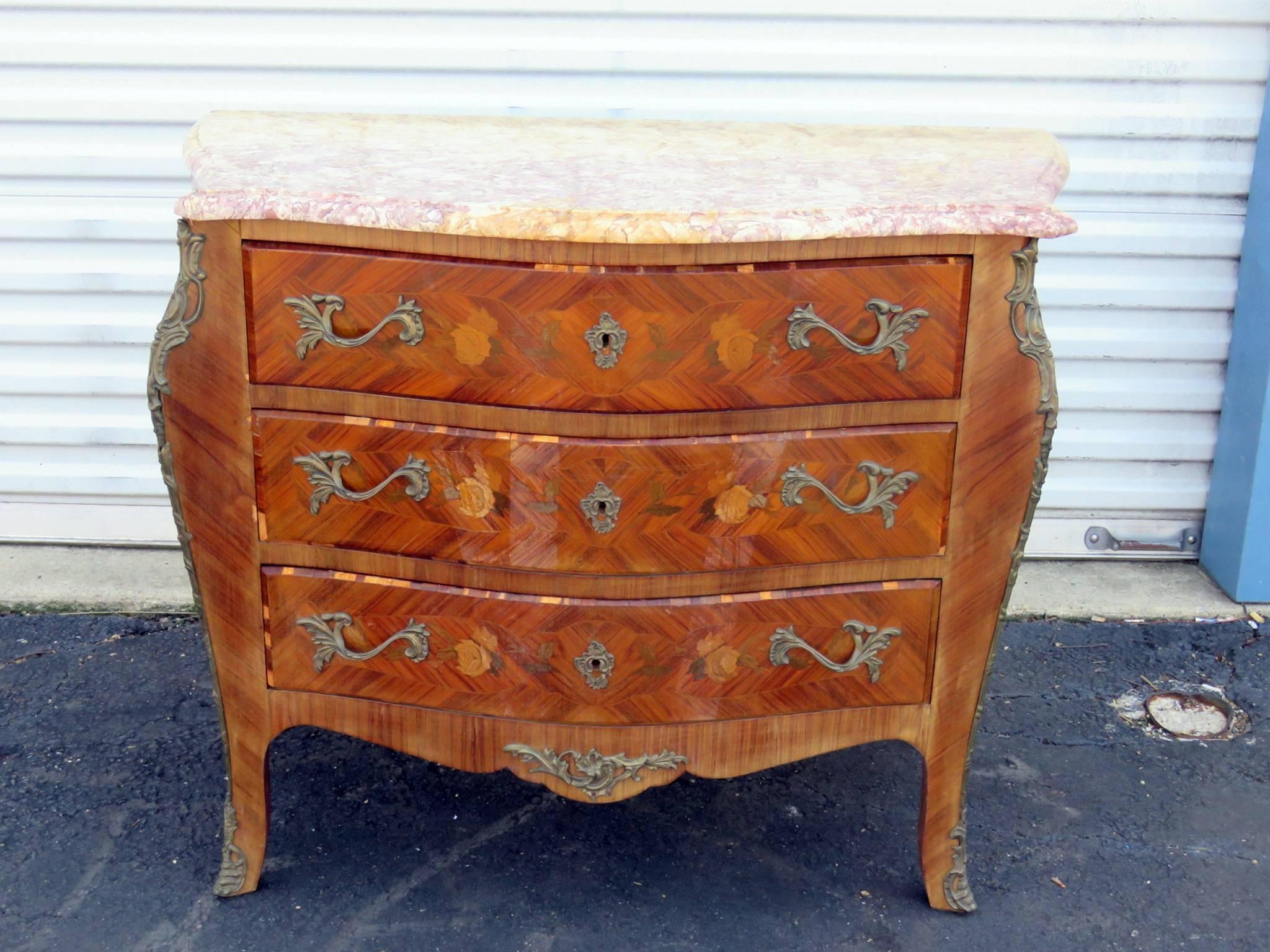 Louis XVI style marble top inlaid commode with three drawers and bronze mounts.