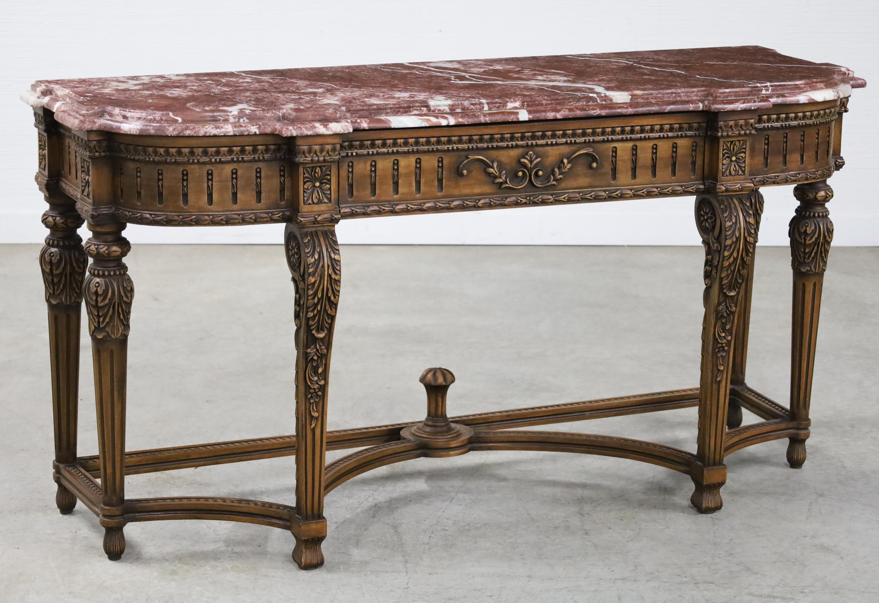 Louis XVI style console with variegated rouge marble top having a single drawer frieze with egg and dart molding, rosette mounted column supports lowering to carved scrolling foliate legs, 20th century