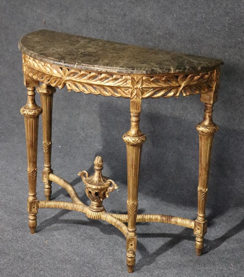 This is a luminous gilt wood hand-carved French Louis XVI Console table. The marble top adds a touch of warmth to the gleeming gold leaf finish. The table is in superb condition and has that time-worn look that tones down the gold leaf so it's not