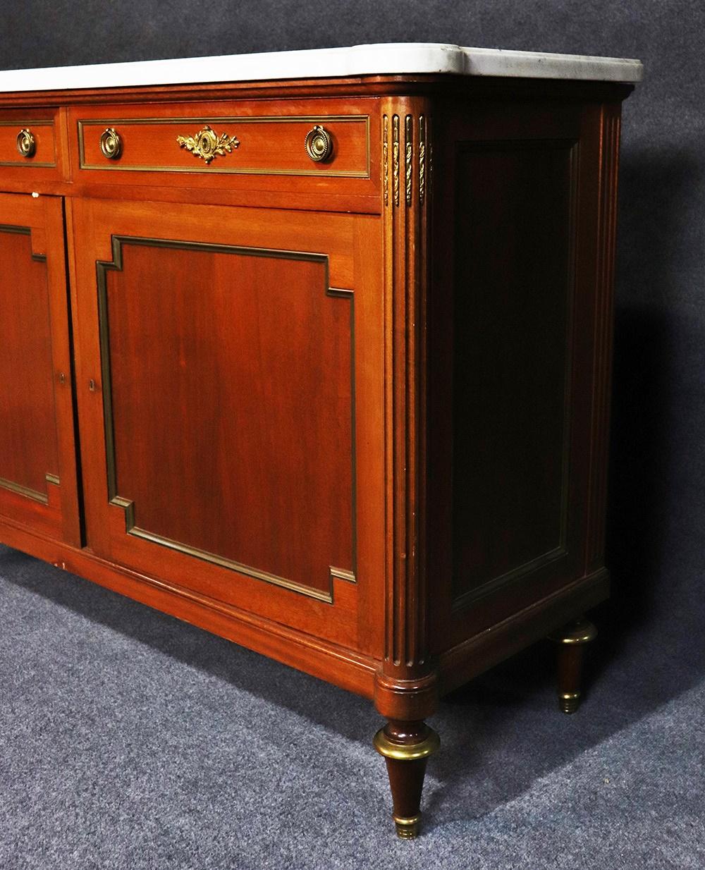 Louis XVI style walnut Carrara marble-top server with 2 drawers over 2 doors each containing 1 adjustable shelf.