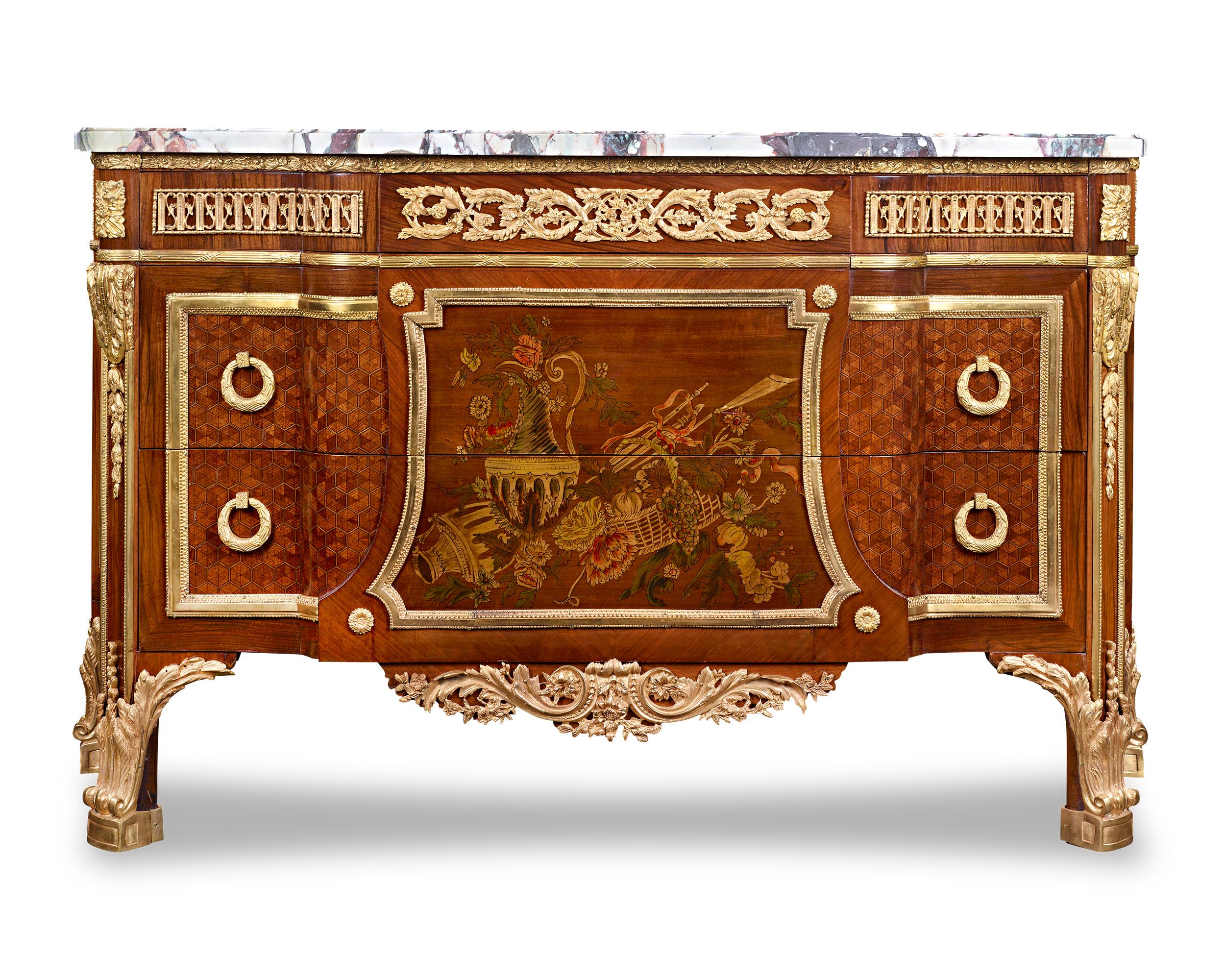 This magnificent pair of French commodes captures the refinement of the Louis XVI style. A highly detailed parquetry design is inlaid into the commodes’ facades and centered by beautiful marquetry still lifes of fruits, flowers and urns. The foliate