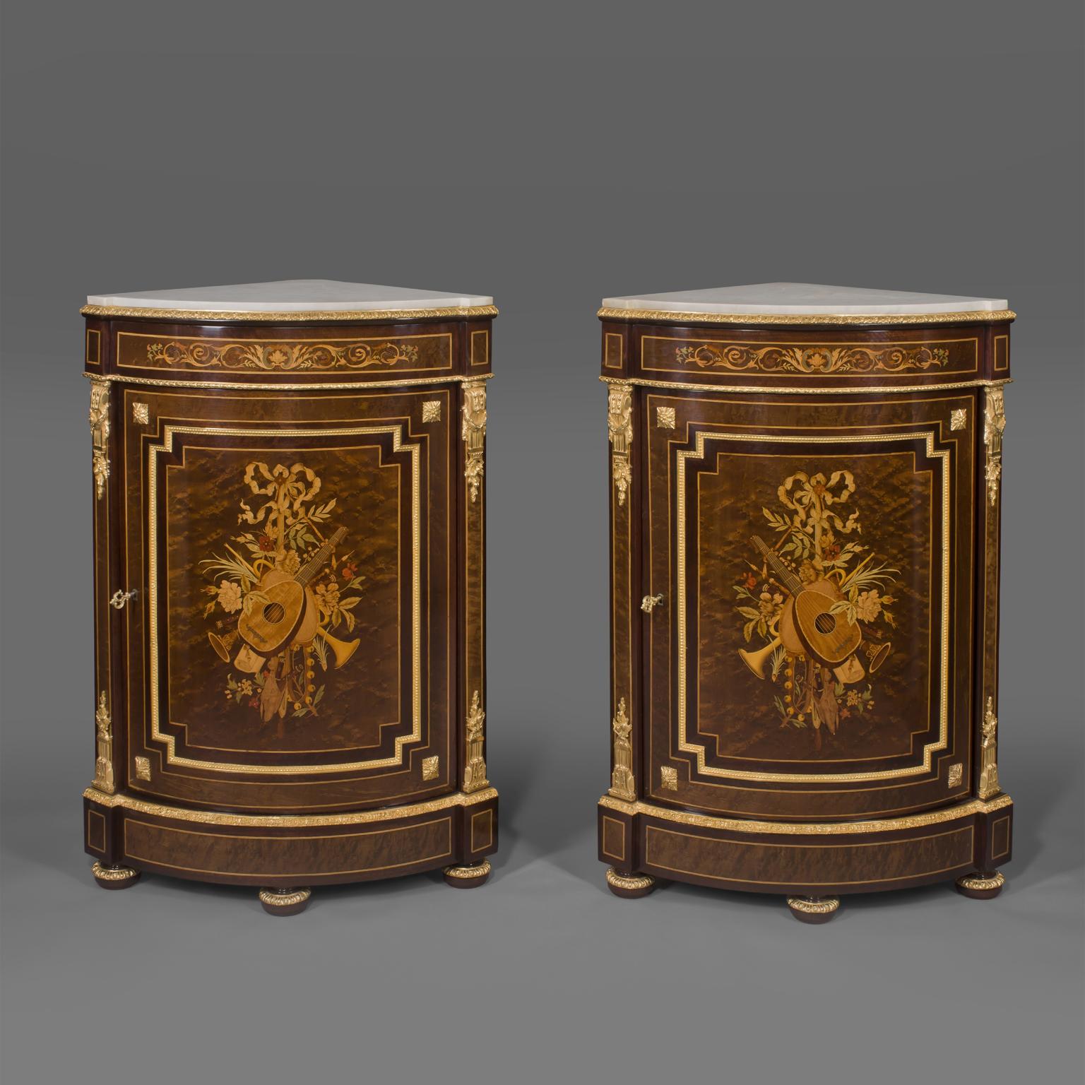 A fine pair of Louis XVI style gilt-bronze and marquetry inlaid Encoignures by Paul Sormani.

Stamped to the reverse of the bronze top rim's 'PS' for Paul Sormani. 

Each corner cupboard has a shaped white marble top and fine gilt-bronze mounts,