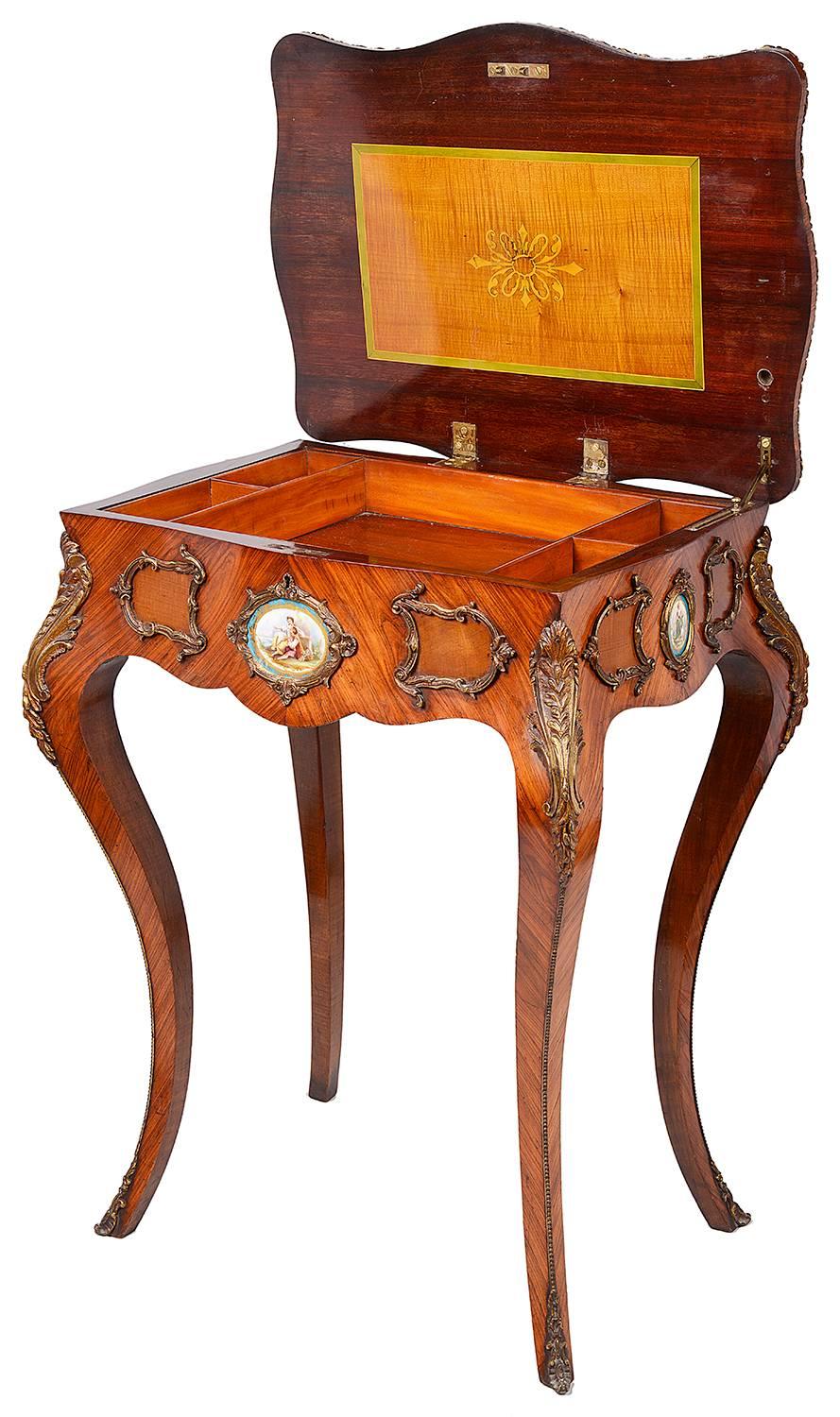 A very good quality 19th century French kingwood marquetry inlaid side table, having a hinged top, opening to reveal a compartmented interior. Sèvres style porcelain plaques inset to the frieze, gilded ormolu mounts and raised on elegant cabriole