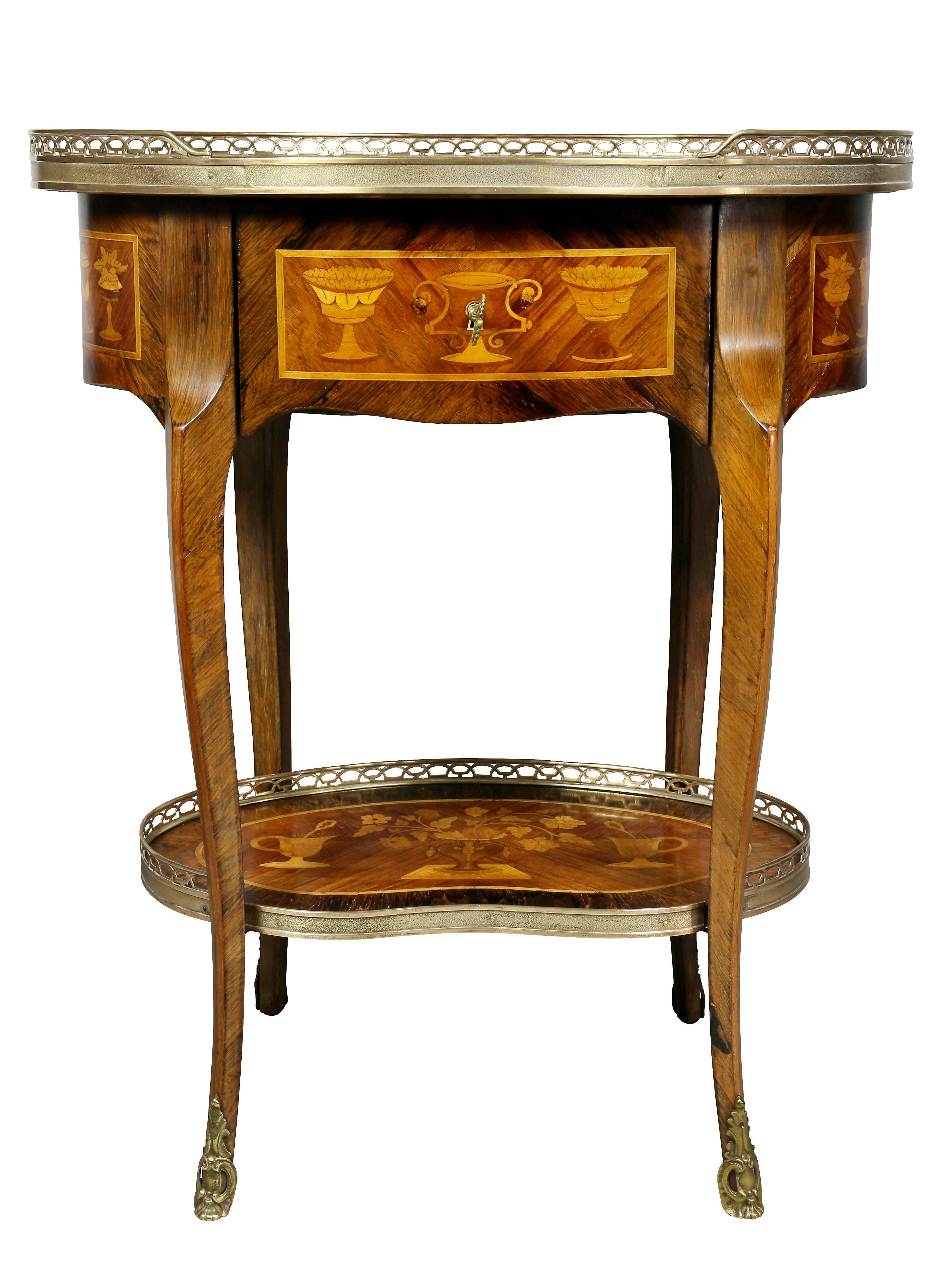 Oval top with inlays and brass gallery over a drawer with all around inlays, raised on shaped cabriole legs and a lower shelf, sabot feet.