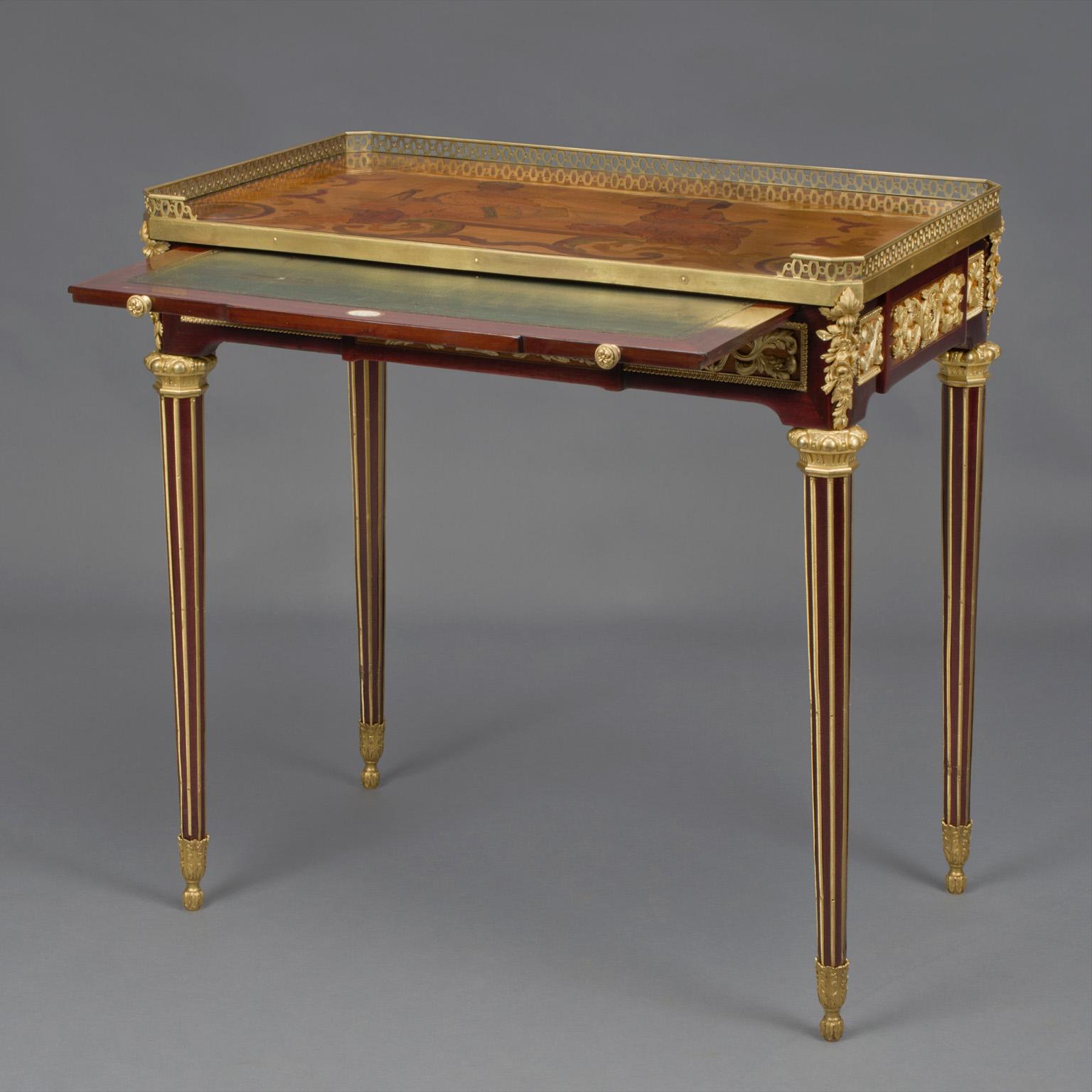 A Louis XVI style gilt bronze mounted mahogany and Marquetry inlaid writing table after the model by Jean-Henri Riesener.

This finely inlaid writing table is based on the famous 'Table des Muses' by the 18th century Royal ébéniste Jean-Henri