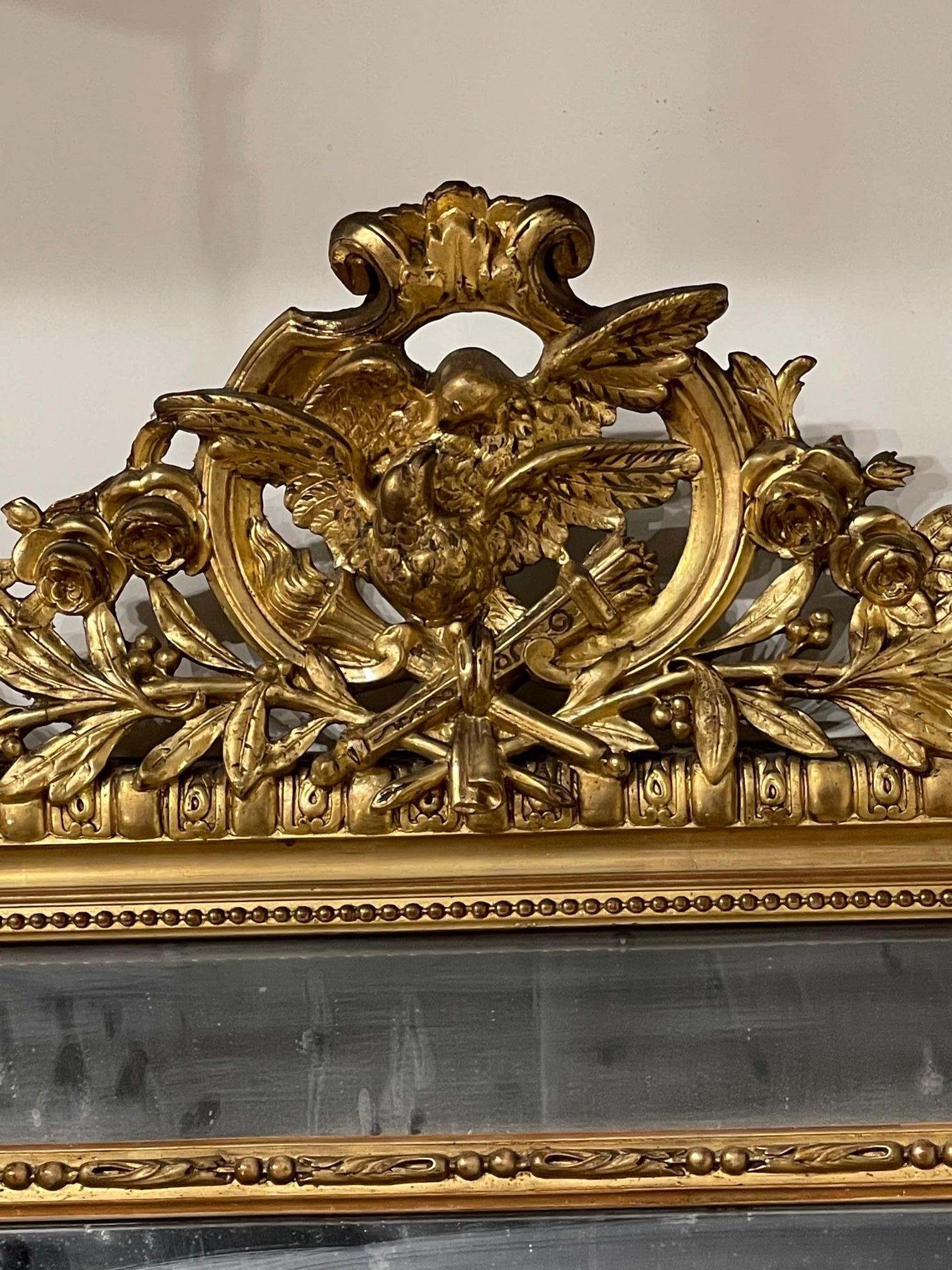 Large scale 19th century French Louis XVI style carved and gilt-wood mirror, Circa 1870. The glass will be cleaned before it is sent out. This is beautiful statement piece.