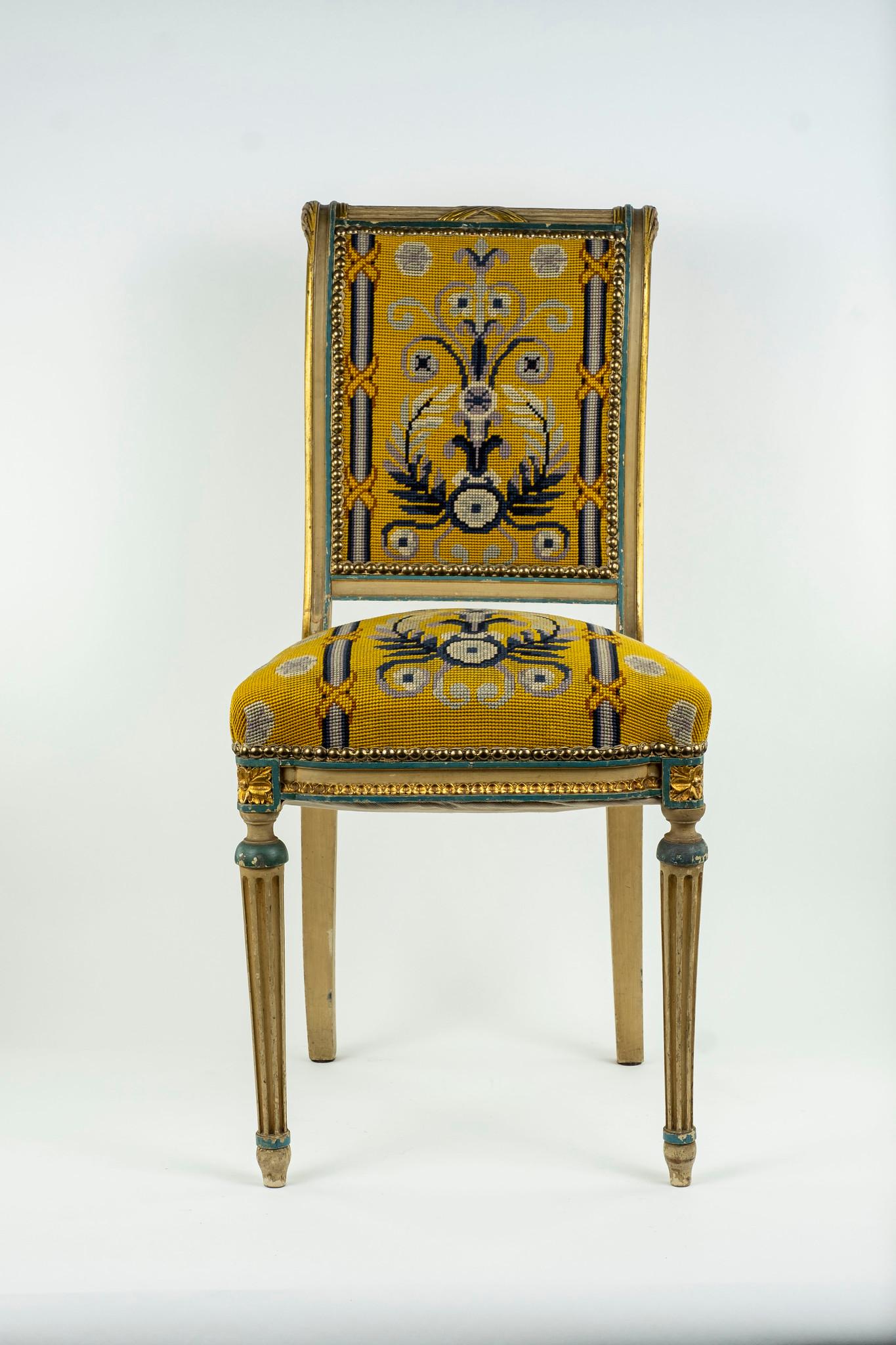 19th century French Louis XVI style chair. Hardwood painted frame with gilded accents upholstered in a classical needlepoint with nailhead detail. Two chairs available, sold by the each.