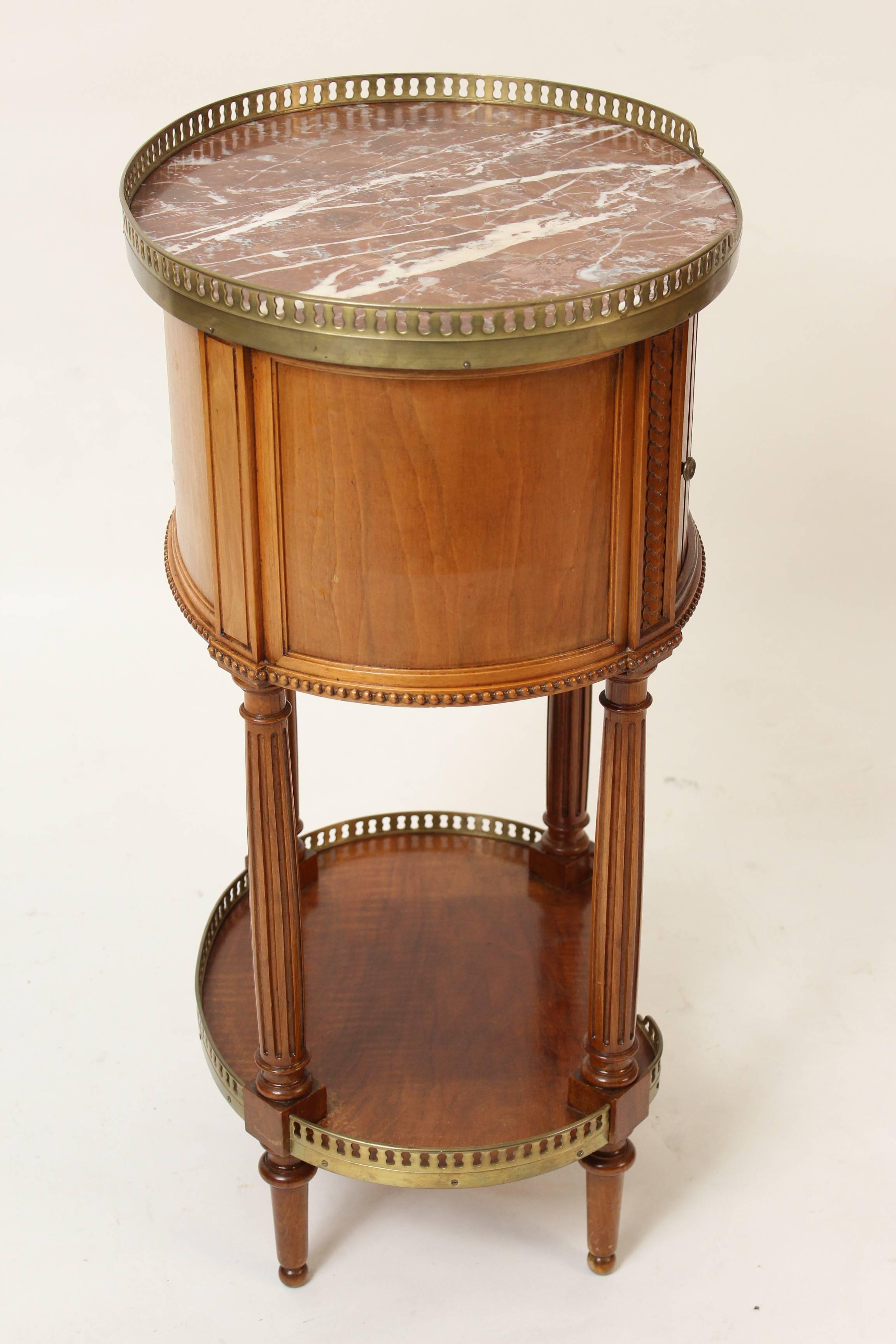 Louis XVI style beechwood occasional table with marble top, brass galleries and tambour door, circa 1930s. Measures: Height to top of brass gallery 30