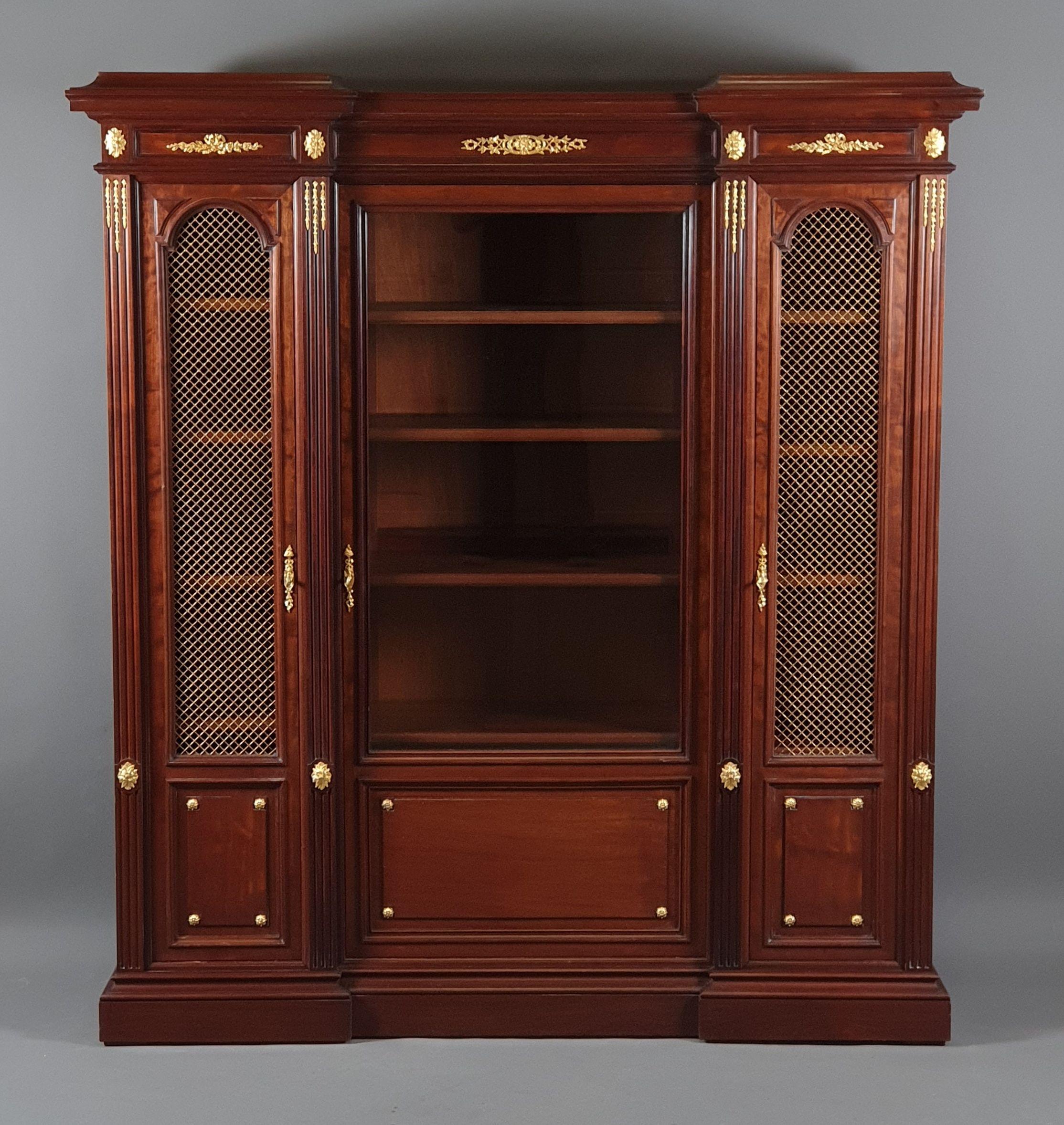 Very elegant Louis XVI style office furniture in solid mahogany and mahogany veneer including :
A middle bureau plat with four fluted legs adorned with very finely chiseled gilt bronze asparagus, fawn leather top with gilt friezes, two retractable