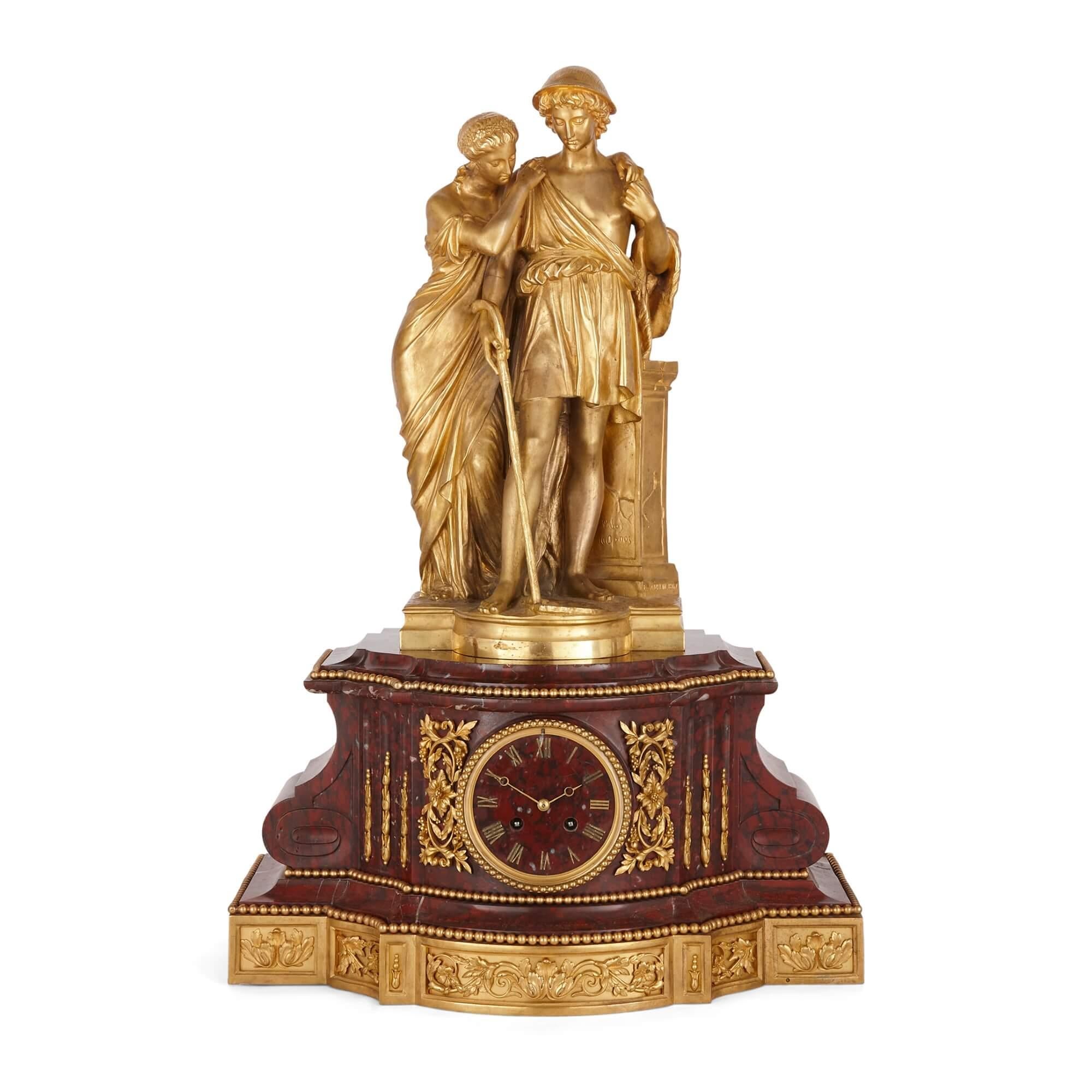 Pendule de style Louis XVI en bronze doré et marbre rouge griotte
Français, 1867
Horloge : hauteur 67cm, largeur 46cm, profondeur 28cm
Chandelier : hauteur 81cm, largeur 34cm, profondeur 34cm

Comprenant une paire de candélabres à six lumières