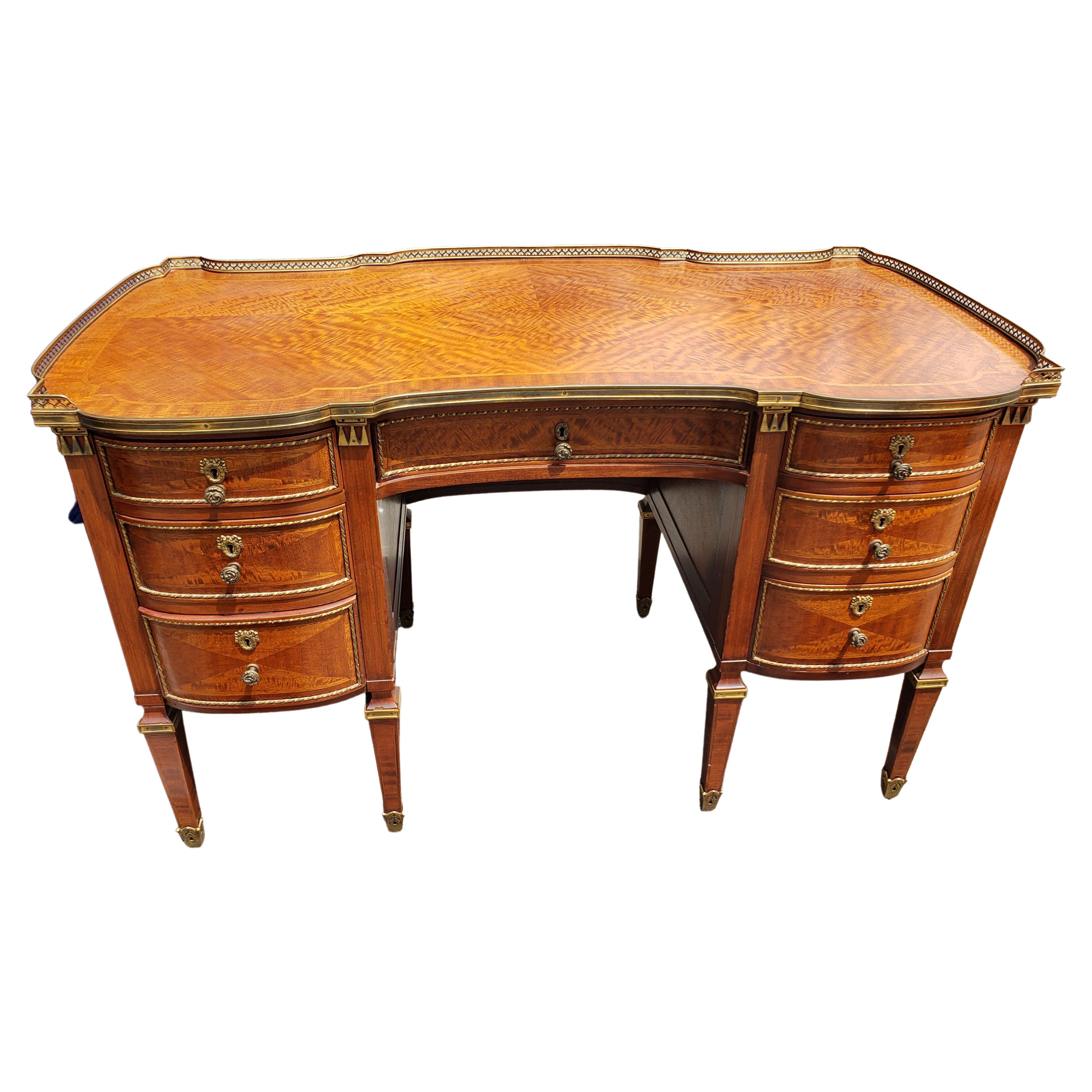 An outsanding Louis XVI Style Ormolu Mounted , Mahogany Burl and Marquetry Desk with top gallery. Very good antique condition. Intricate Marquetry work all over to the legs terminating cast brass sabot. Very sturday with dovetail drawers functioning