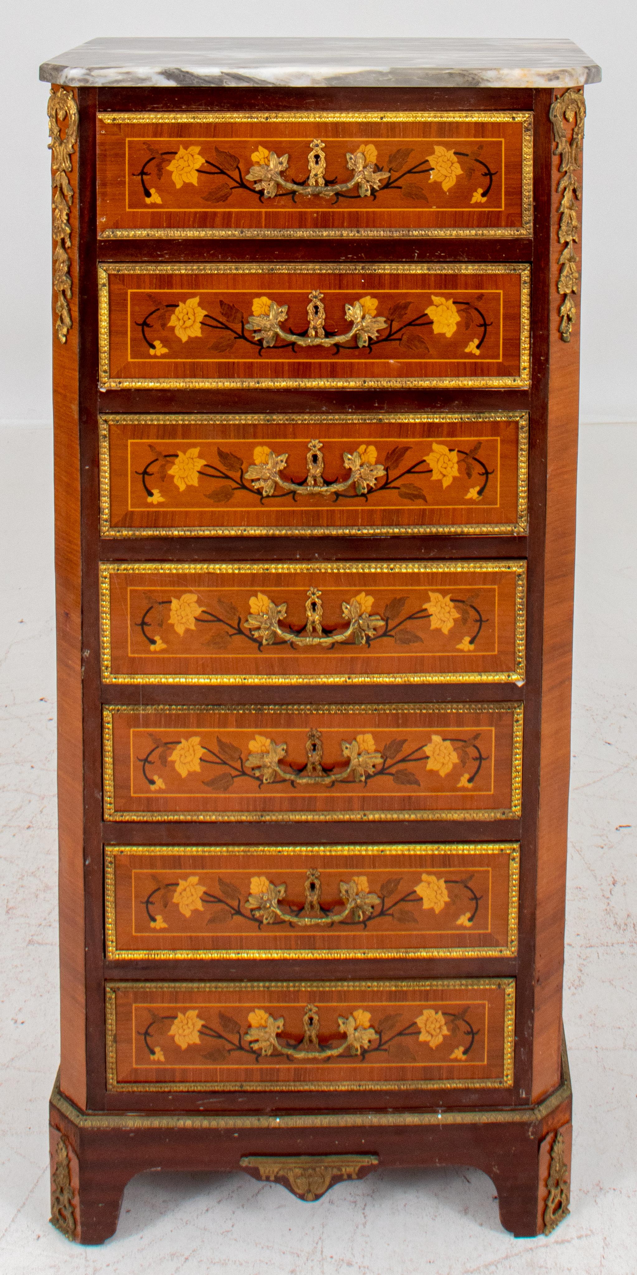 Louis XVI style ormolu-mounted marquetry semainier or seven-drawered tall dresser, rectangular with a gray onyx top, each drawer with floral marquetry designs, the whole with floral mounts.

Dealer: S138XX