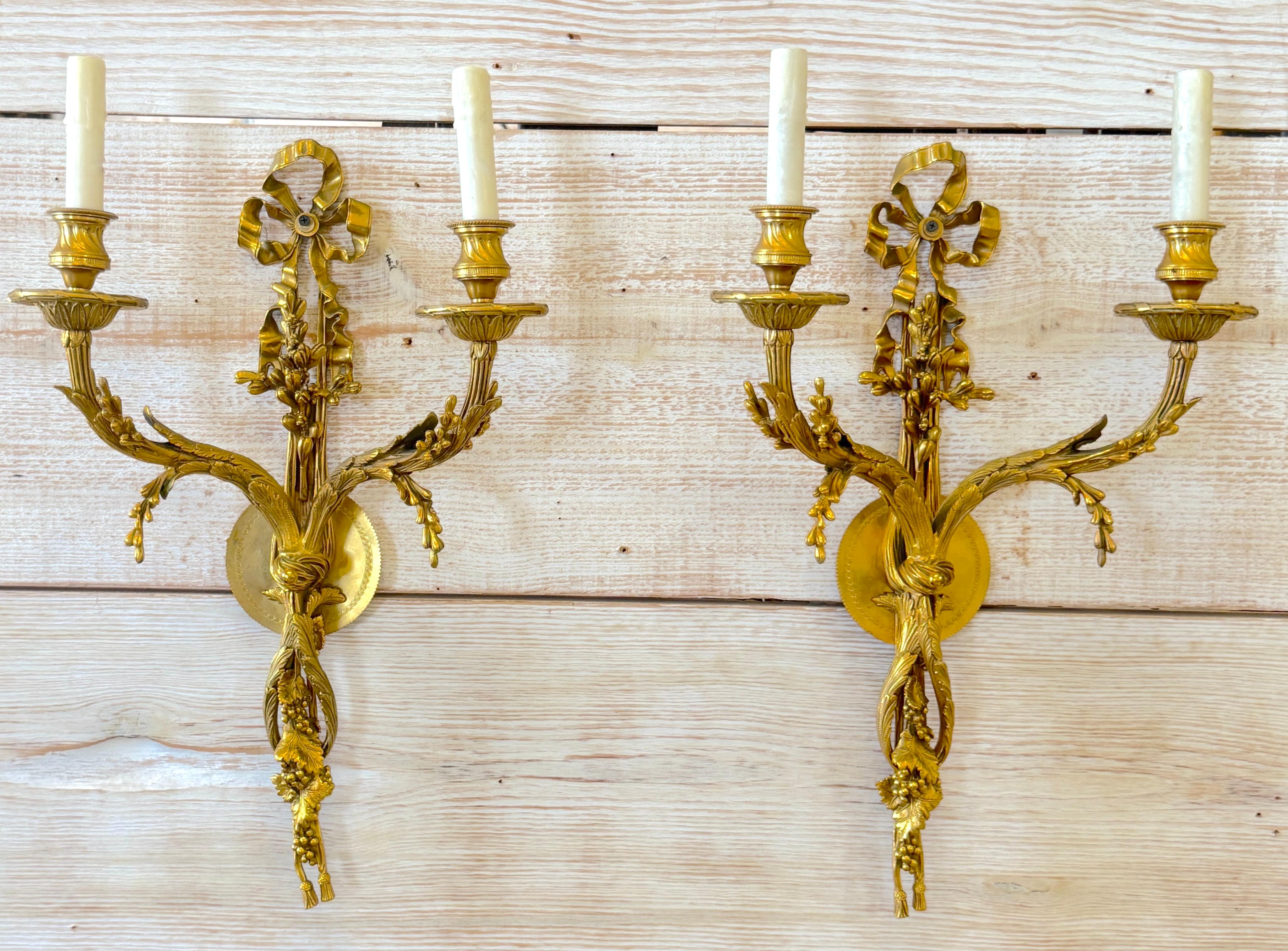 Pair of Louis XVI Style Ormolu Two‑Light Sconces, Attributed to P.E. Guerin, 20th Century

A finely cast and chased pair of Louis XVI style gilt‑bronze (ormolu) two‑light wall sconces, attributed to the esteemed New York foundry P.E. Guerin, known
