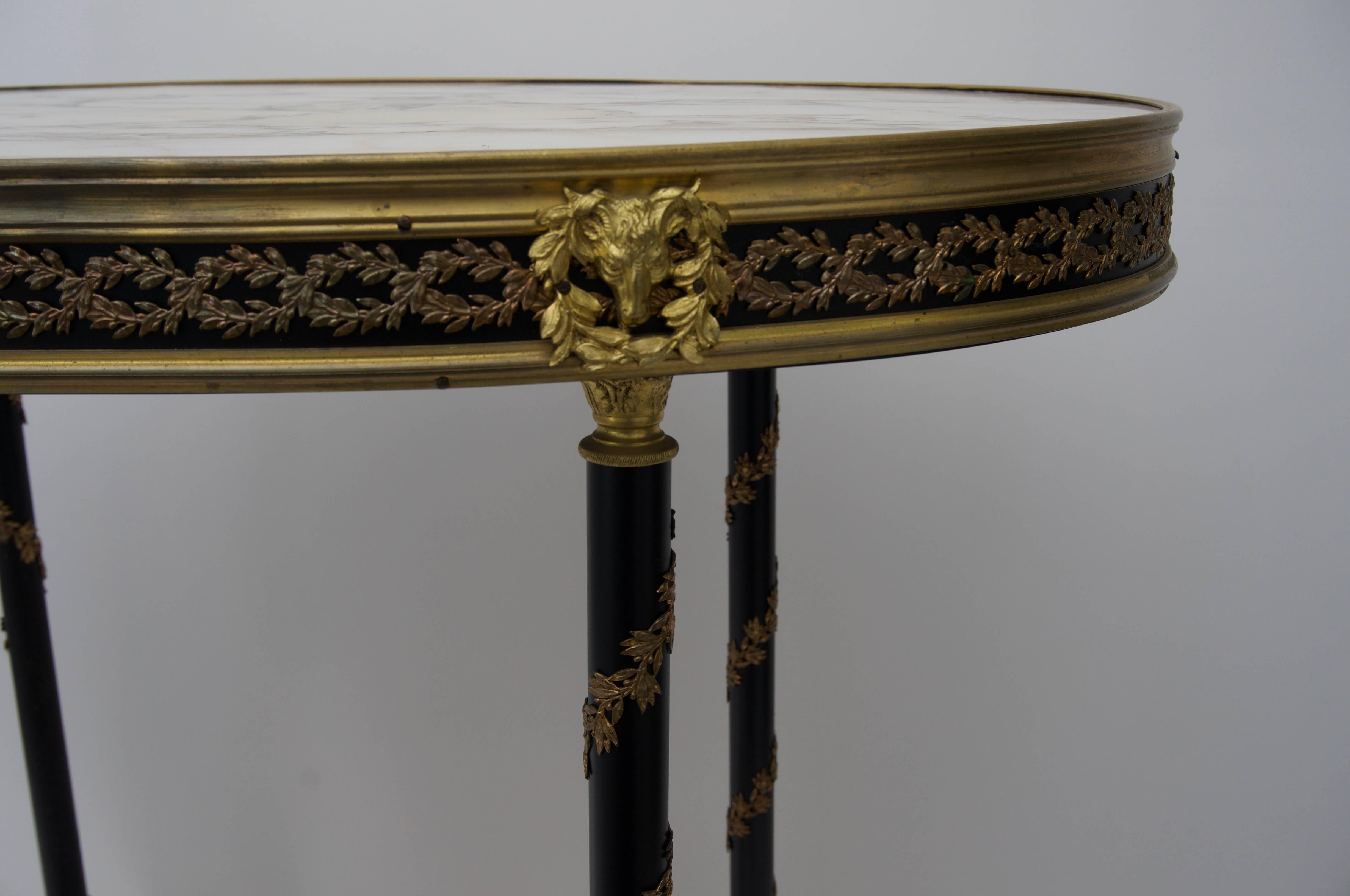 This stylish 19th century French, Louis XVI Style gueridon table with its cast bronze doe hoof feet, garlands, rams heads and serpentine stretcher was 
 recently acquired from a Palm Beach estate. 
     