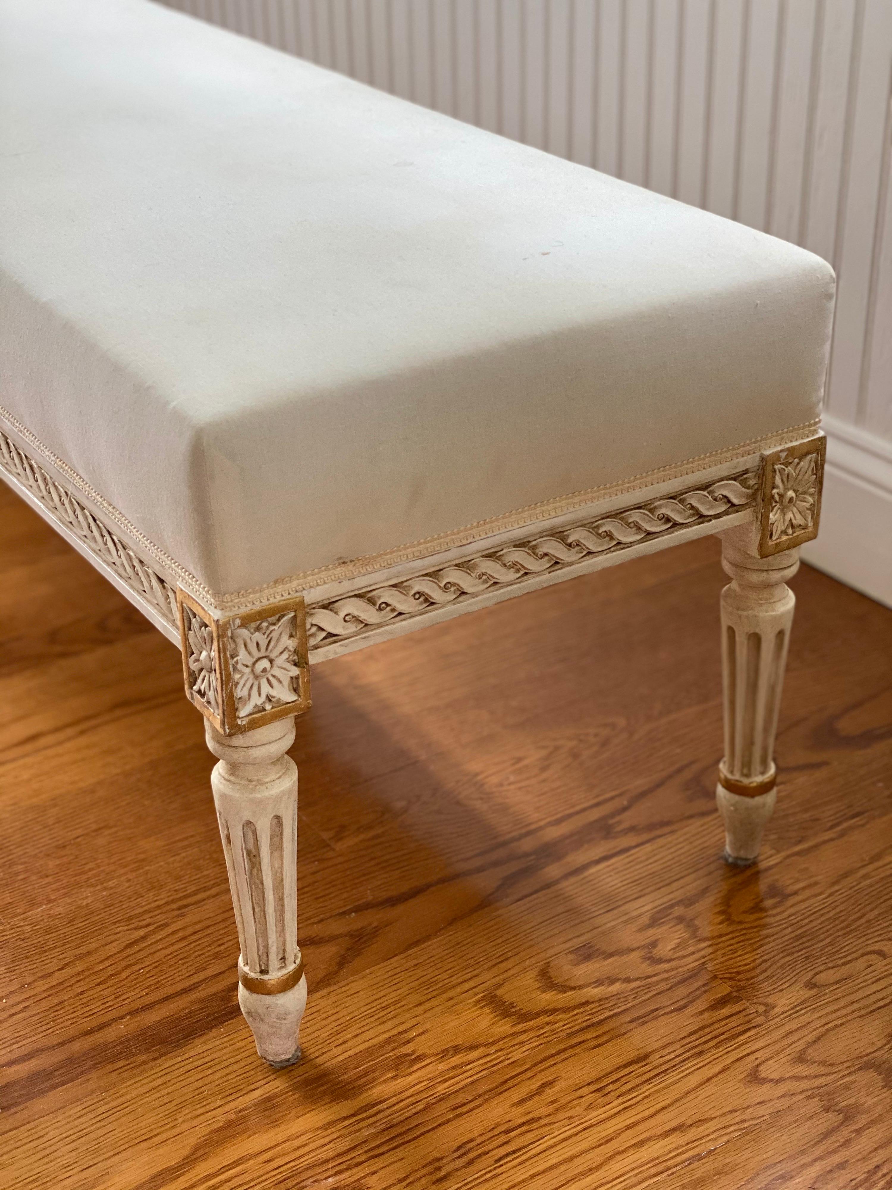 Louis XVI style painted and parcel-gilt banquette/bench, early 20th century
Classic French design, great proportions and good condition.
Squared Rosette, fluted, tapered legs and covered in cotton muslin with narrow tape trim running all