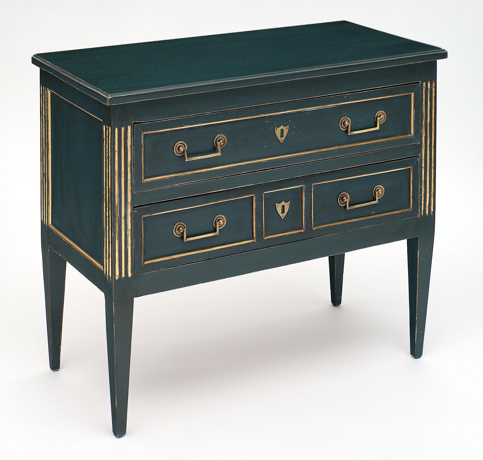 Fine painted antique Louis XVI style French chest of drawers made of solid walnut. It features square brass pulls on two dovetailed drawers. The blue patina gives it a unique look, and we love the gilt brass throughout. It has elegant proportions,