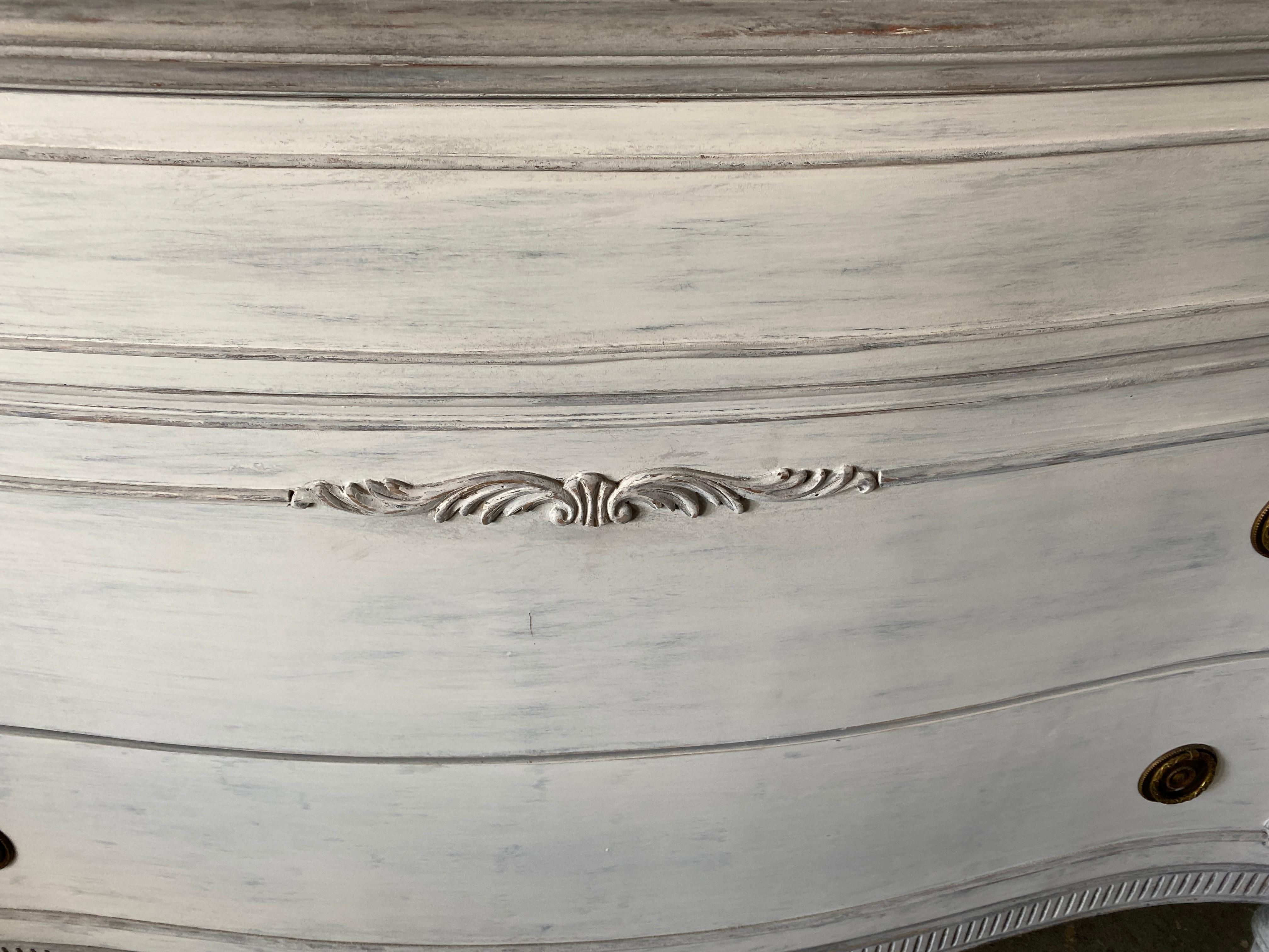 Vintage French Louis XVI Style painted dresser with 3 large drawers for storage.  Paint has a slight blue grey tint with light grey edge detail.
The style is suitable for various decor, including Swedish Gustavian, classical, neoclassical, French