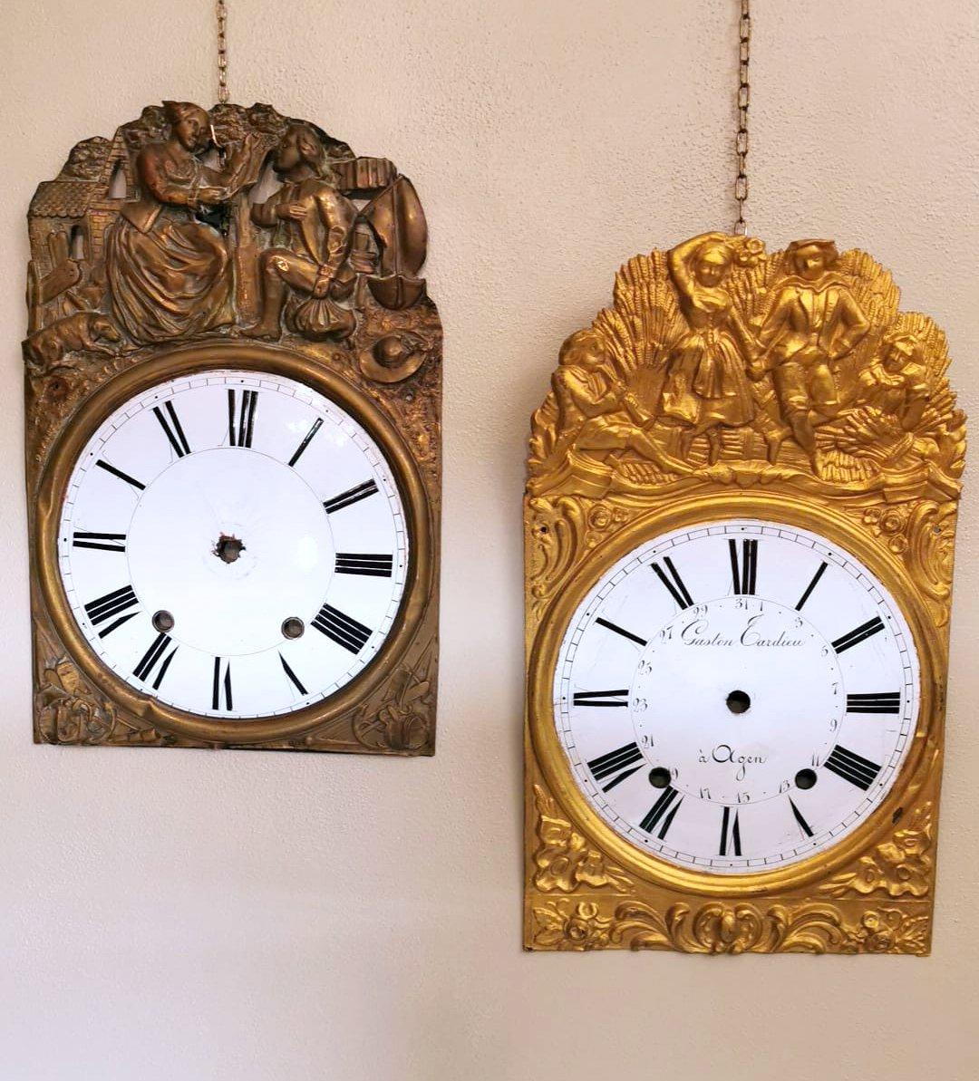 These two particular pediments were originally parts of antique pendulum clocks; the central circular portion is in white fire enamel with fine Roman numerals in black and is set on an embossed and gilded brass plate; on the gilded and burnished one
