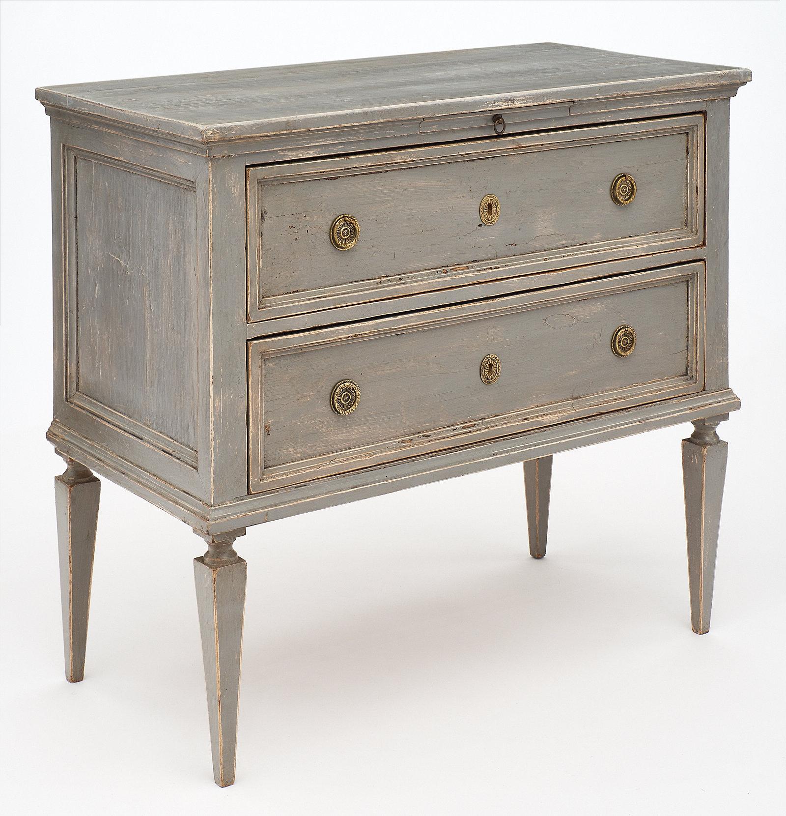 A pair of Tuscan Louis XVI style “commodes”. These Italian chests feature a blue-gray patina with finely cast bronze hardware. We loved the construction and the flawless lines. They are made of solid fir and each have a pull-out leaf above the two