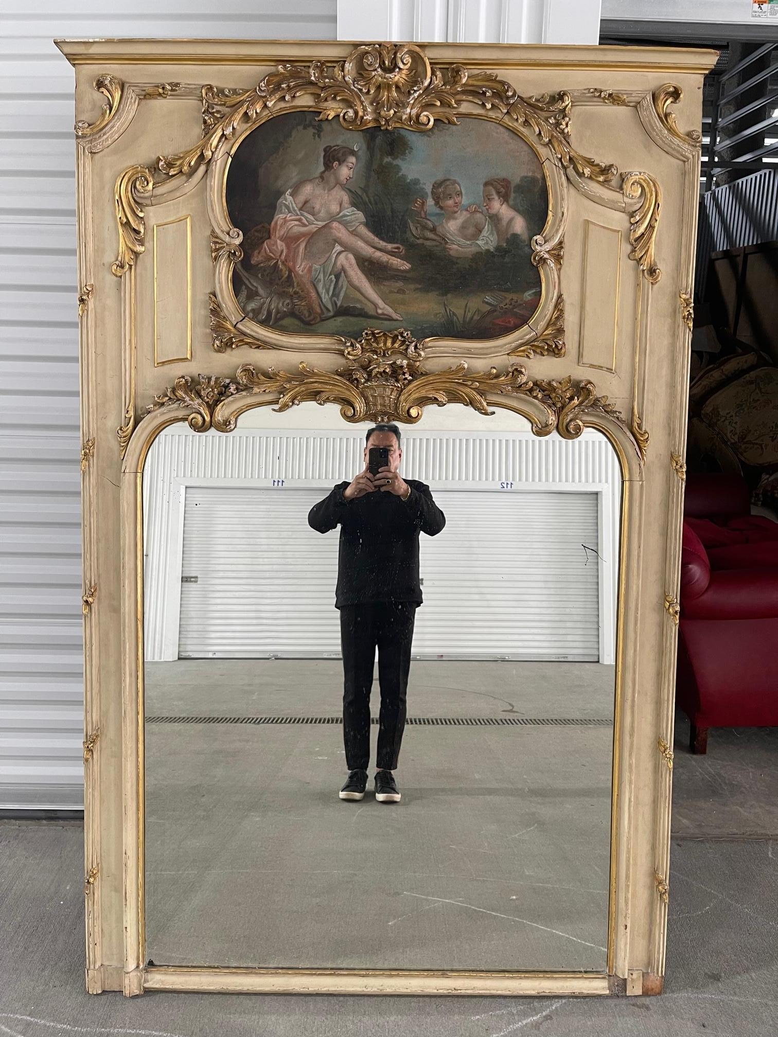 Louis XVI style parcel giltwood trumeau mirror, early 19th century. Fine oil painting depicting a trio of young women in a Classical garden setting.