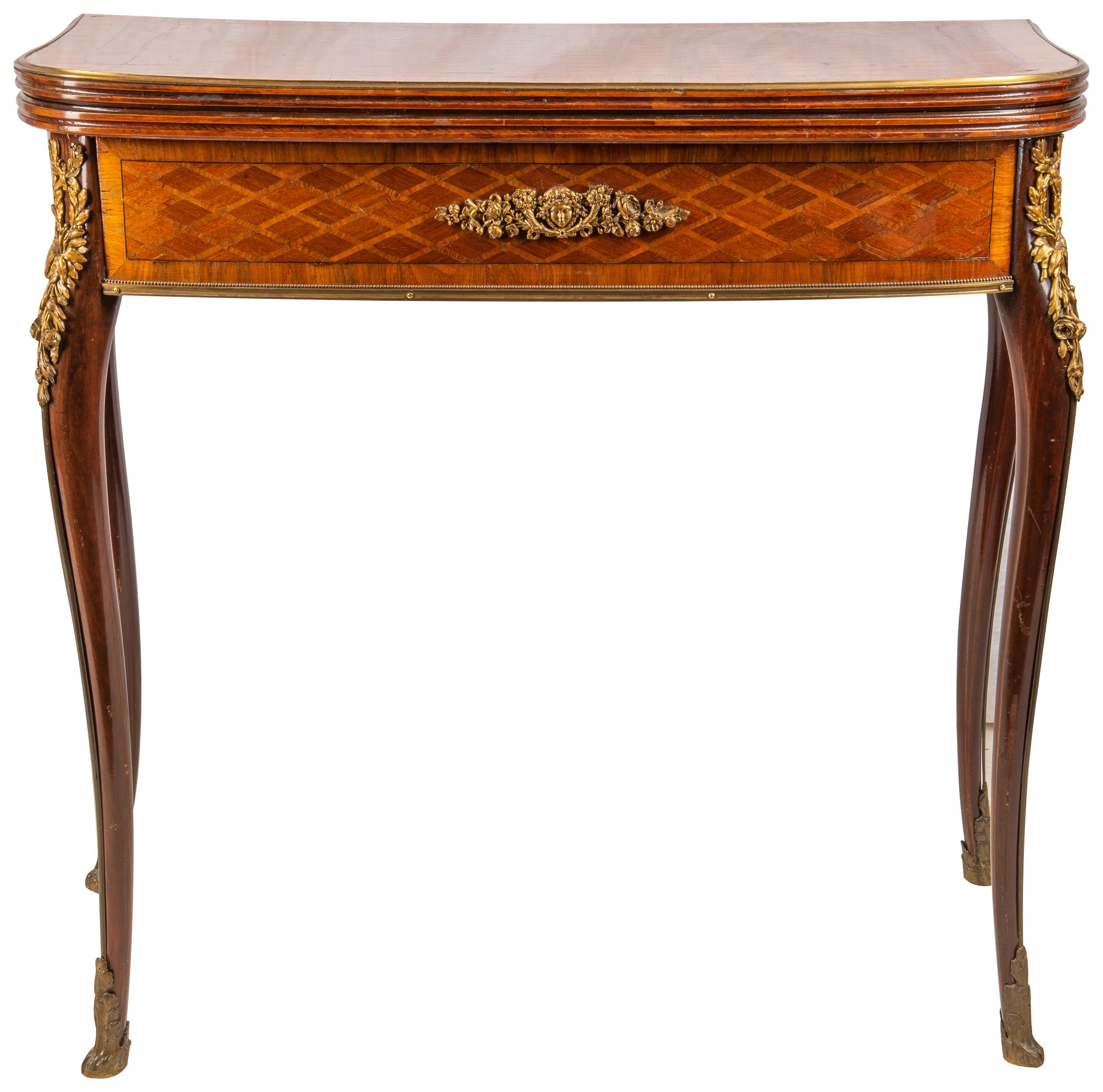 A very good quality late 19th century French parquetry inlaid folding card table in the Louis XVI style. The top opening to reveal a card table, parquetry inlay also to the frieze, gilded ormolu mounts, and raised on elegant cabriole legs.
In the
