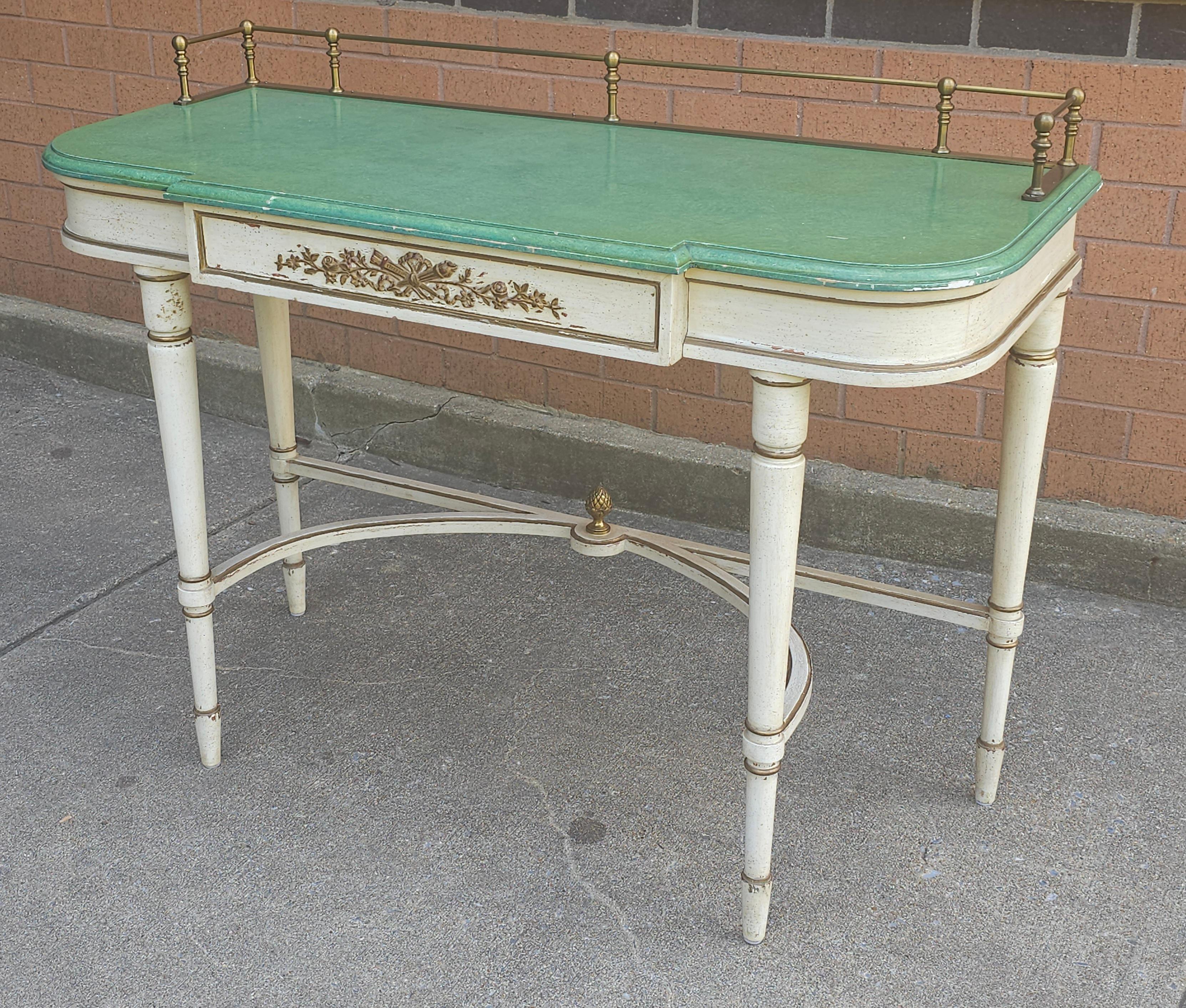 A Louis XVI Style Partial Gilt, Cream and Green Enamel Painted Console Table with brass gallery. Measures 42