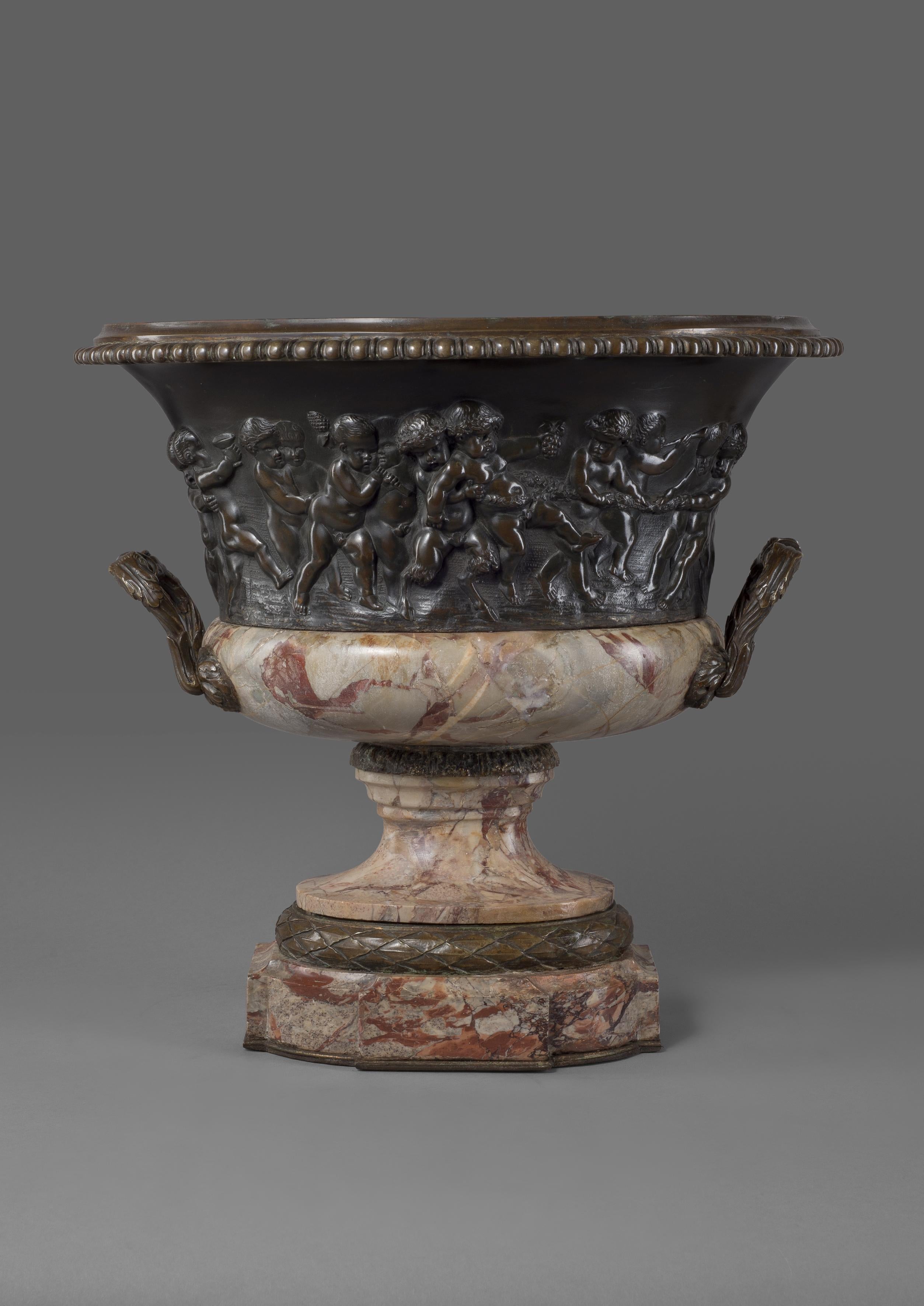 A Louis XVI style patinated bronze and marble jardinière, cast in relief with Bacchanalian Scenes Of Putti at Play, After Clodion.

French, circa 1870. 

The body of the jardinière or vase depicts a charming scene of putti at play in the manner