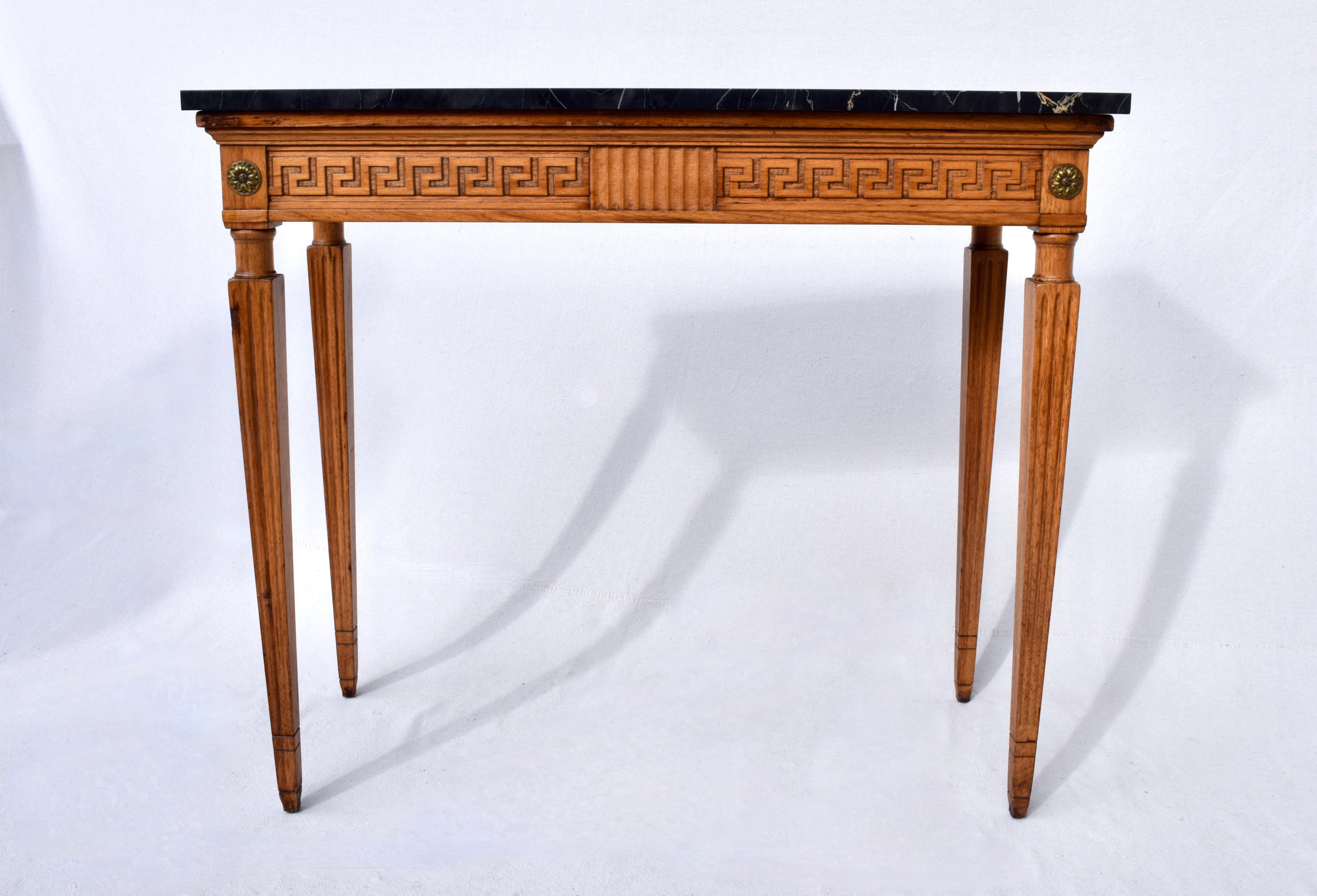 Italian Portoro marble top Louis XVI style console table with oak base featuring Greek key styling, tapered carved reed legs accented with brass rosettes. Exquisite lithe lines with removable top suitable for placement in a variety of settings.