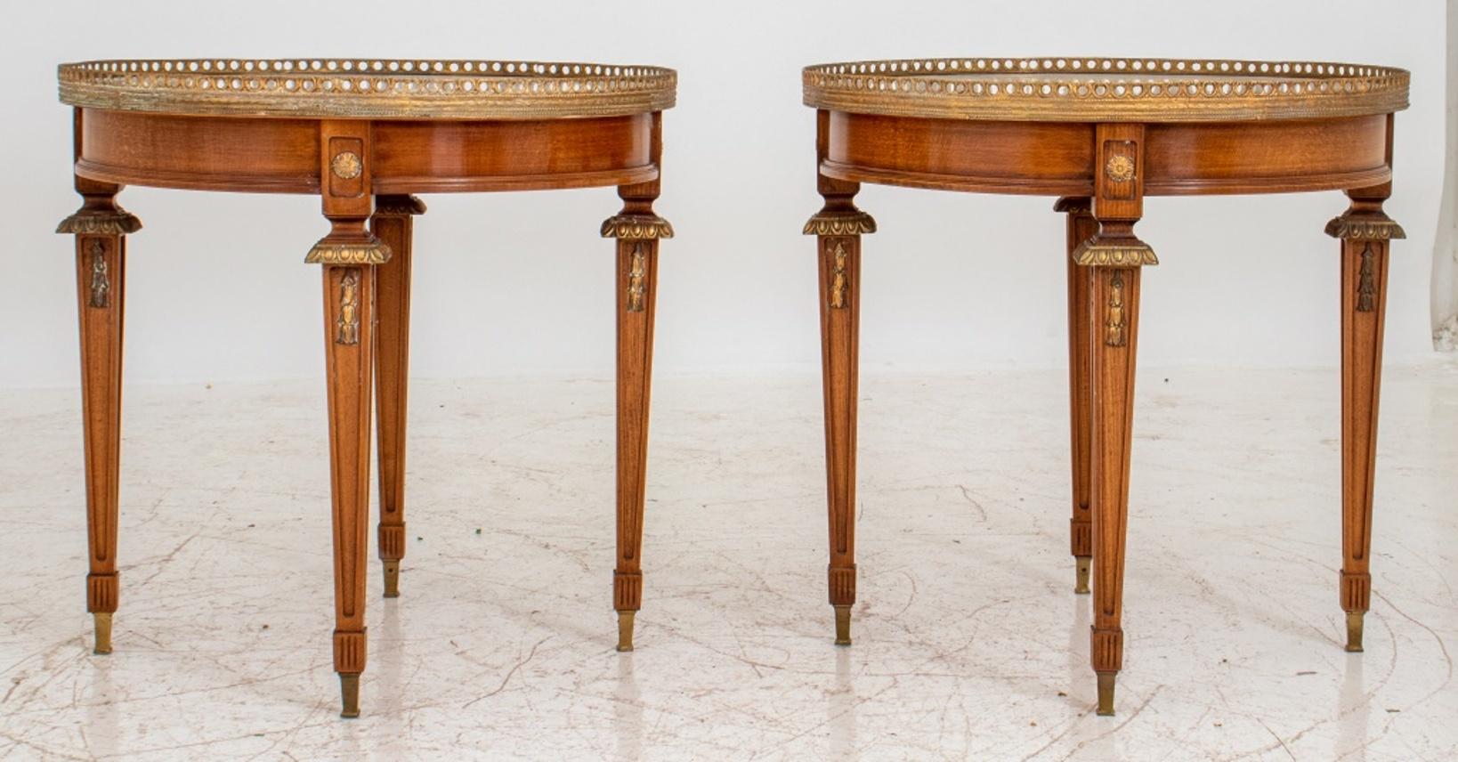 Louis XVI gilt metal mounted mahogany white marble-topped round bouillotte tables, with galleried gilt metal tops and white Carrara marble surfaces, above four square tapering legs on toupie feet. 25.5