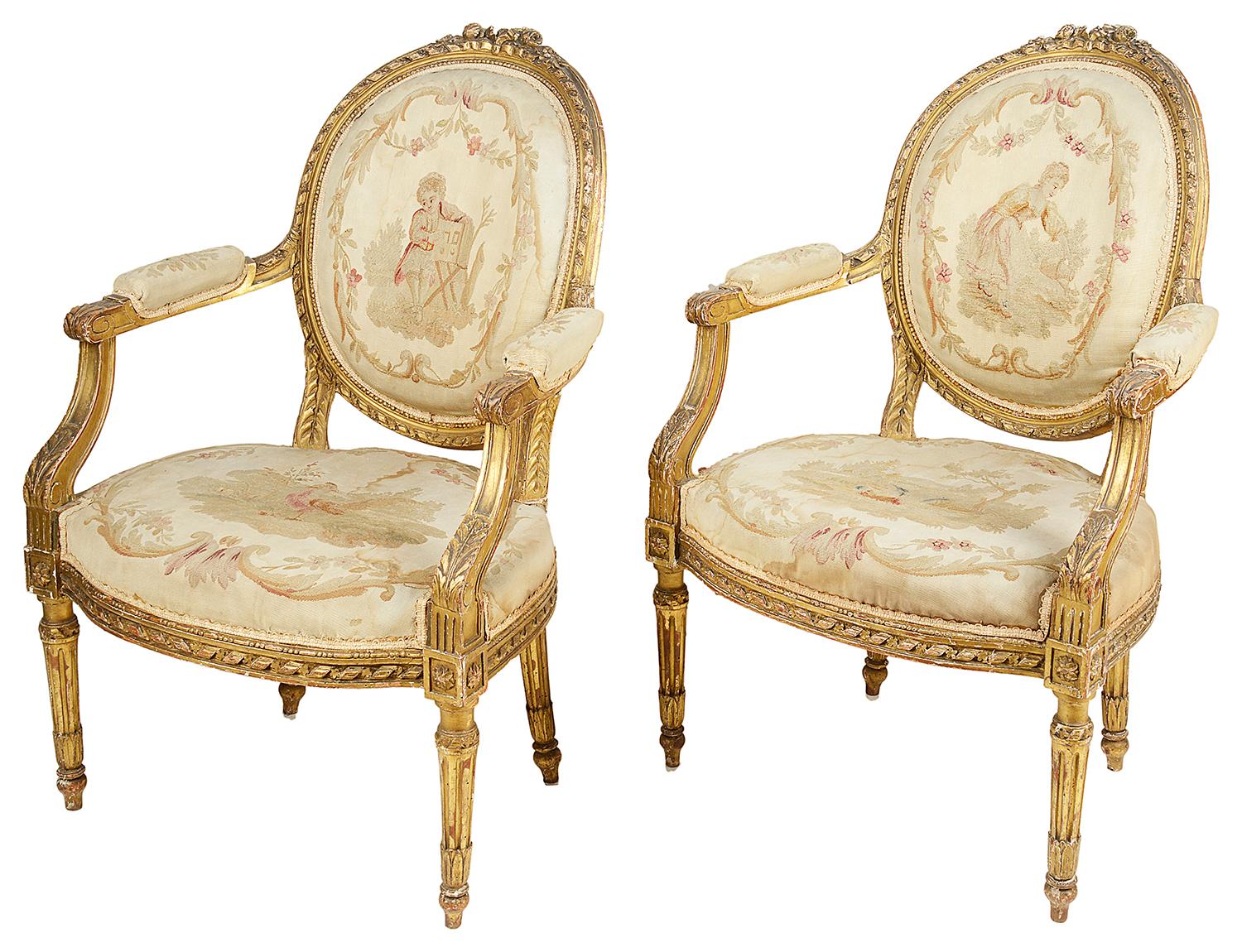 A good quality 19th century carved giltwood salon suite, comprising of four armchairs and a matching sofa.
Each chair and the sofa having carved ribbon and foliate decoration, tapestry backs and seats, depicting various rural scenes of men and