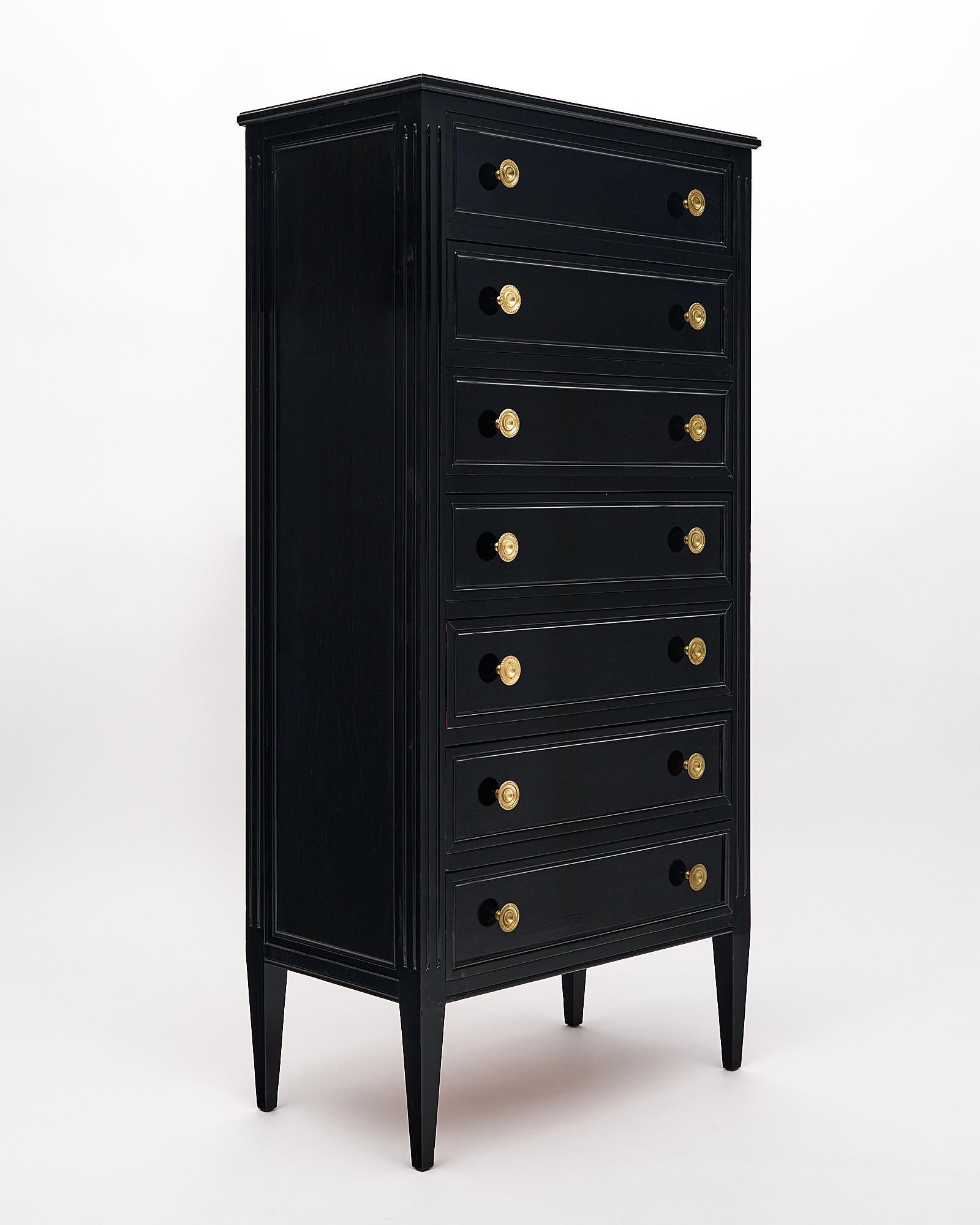 Semainier, chest of sever dovetailed drawers with the original finely cast gilt brass pulls. This French piece is in the Louis XVI style and finished with a museum quality ebonized French polish for a striking luster.