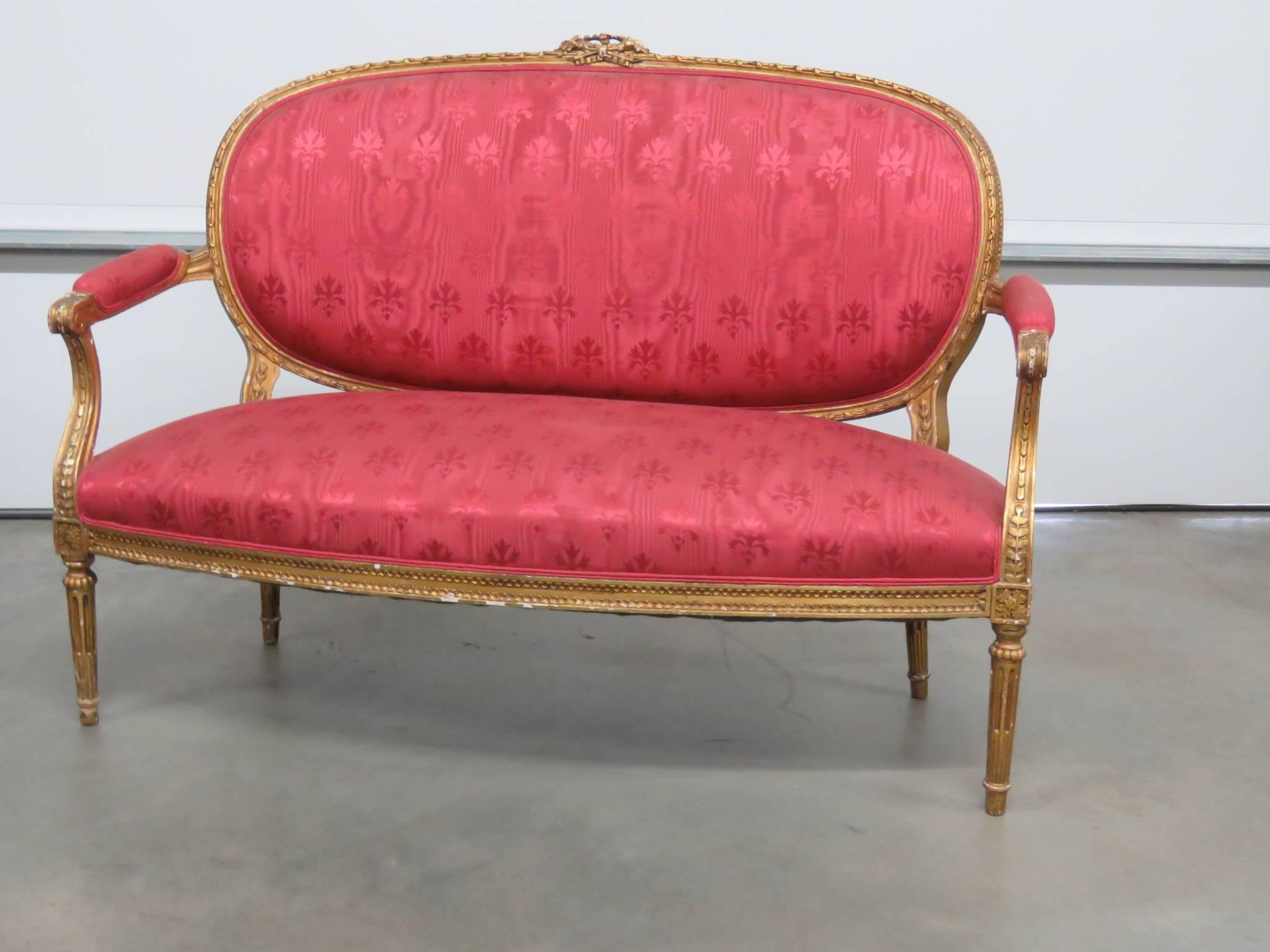 Louis XVI style giltwood settee. Measures: 18.5