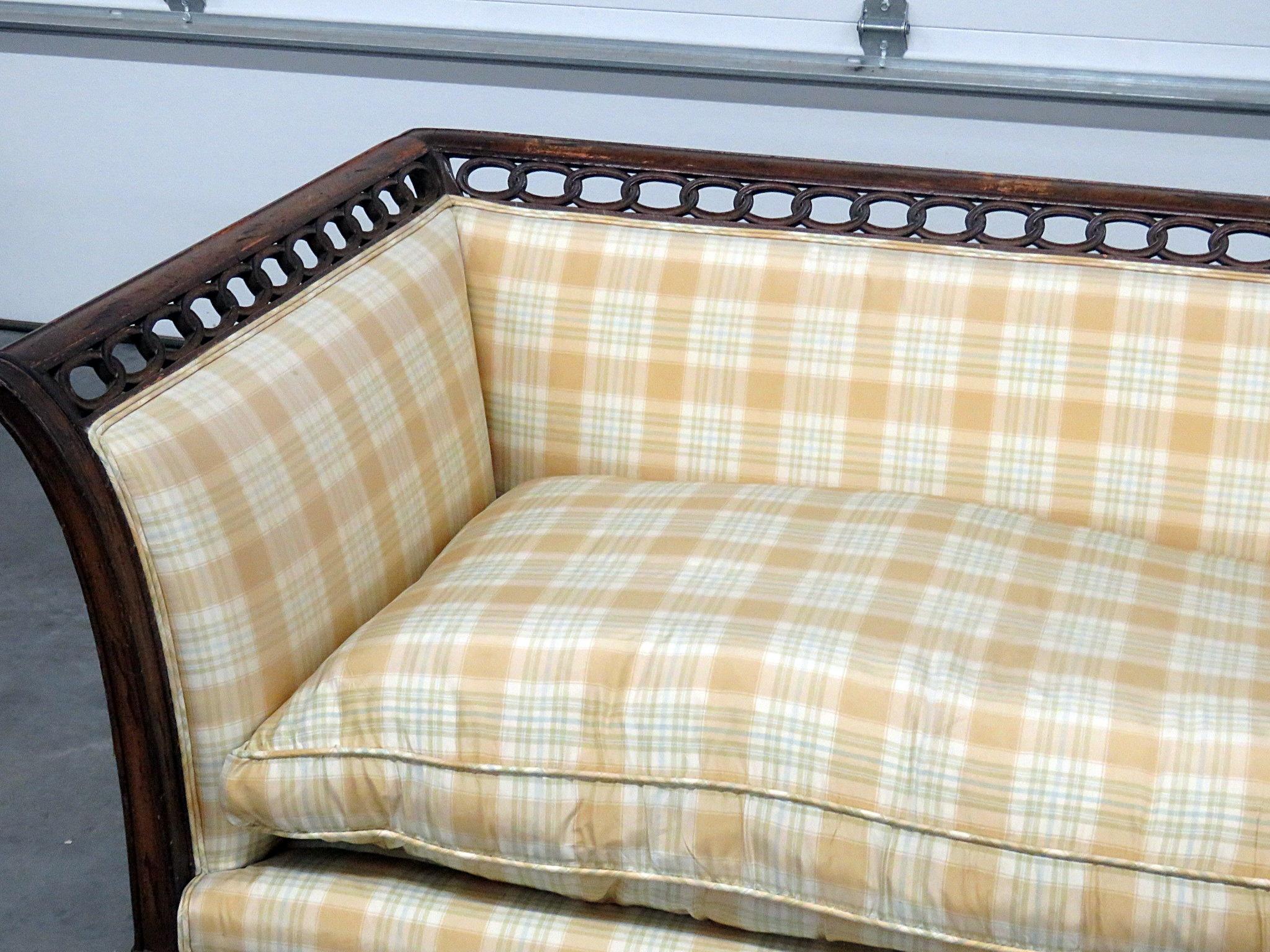 Louis XVI style settee with a distressed finish.