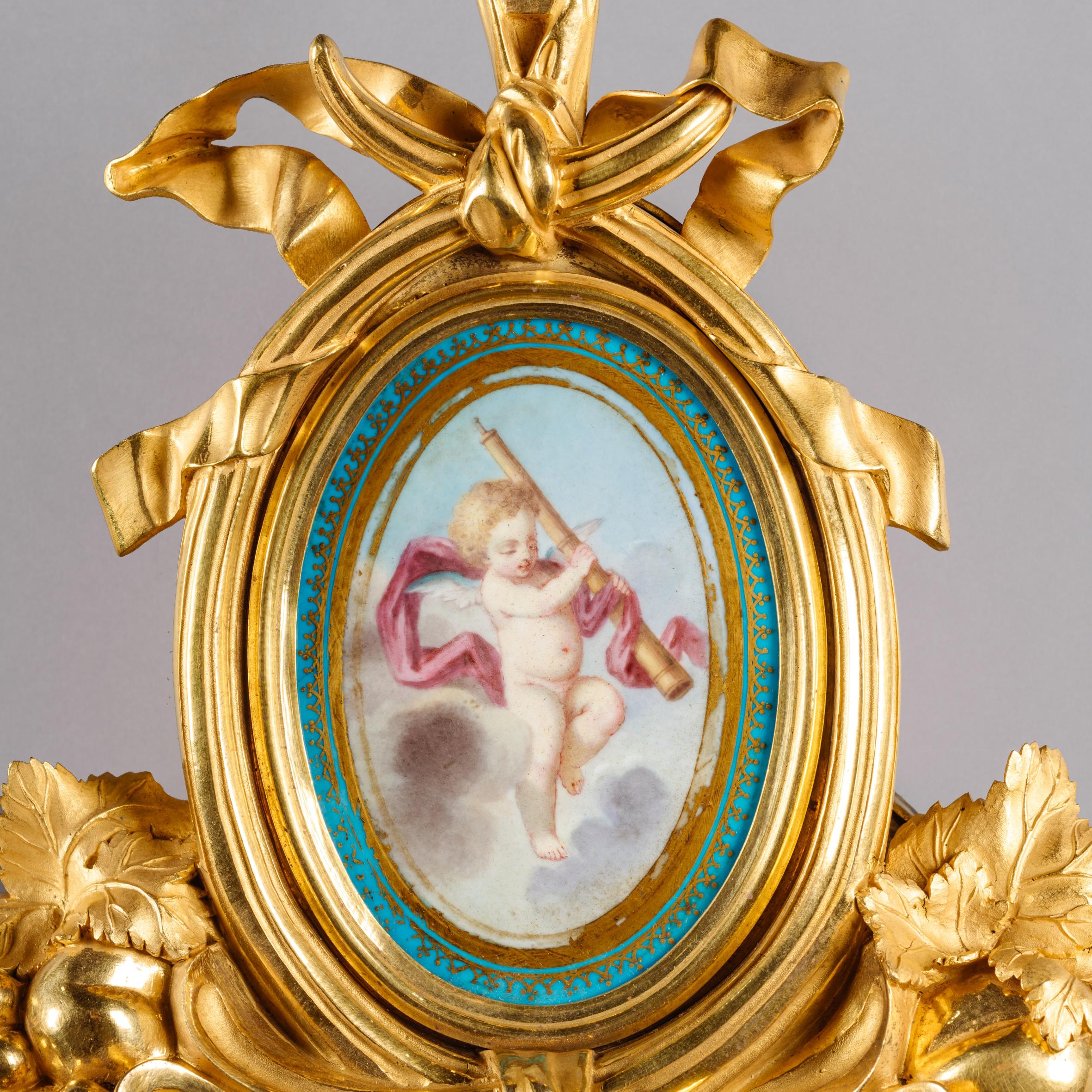 A Fine Louis XVI Style Gilt-Bronze and Sèvres Porcelain Mounted Cartel Clock and Aneroid Barometer En Suite, After the Models by Martinout and Passemant. 

The clock having a circular eight-day twin-train movement with anchor escapement Brocot