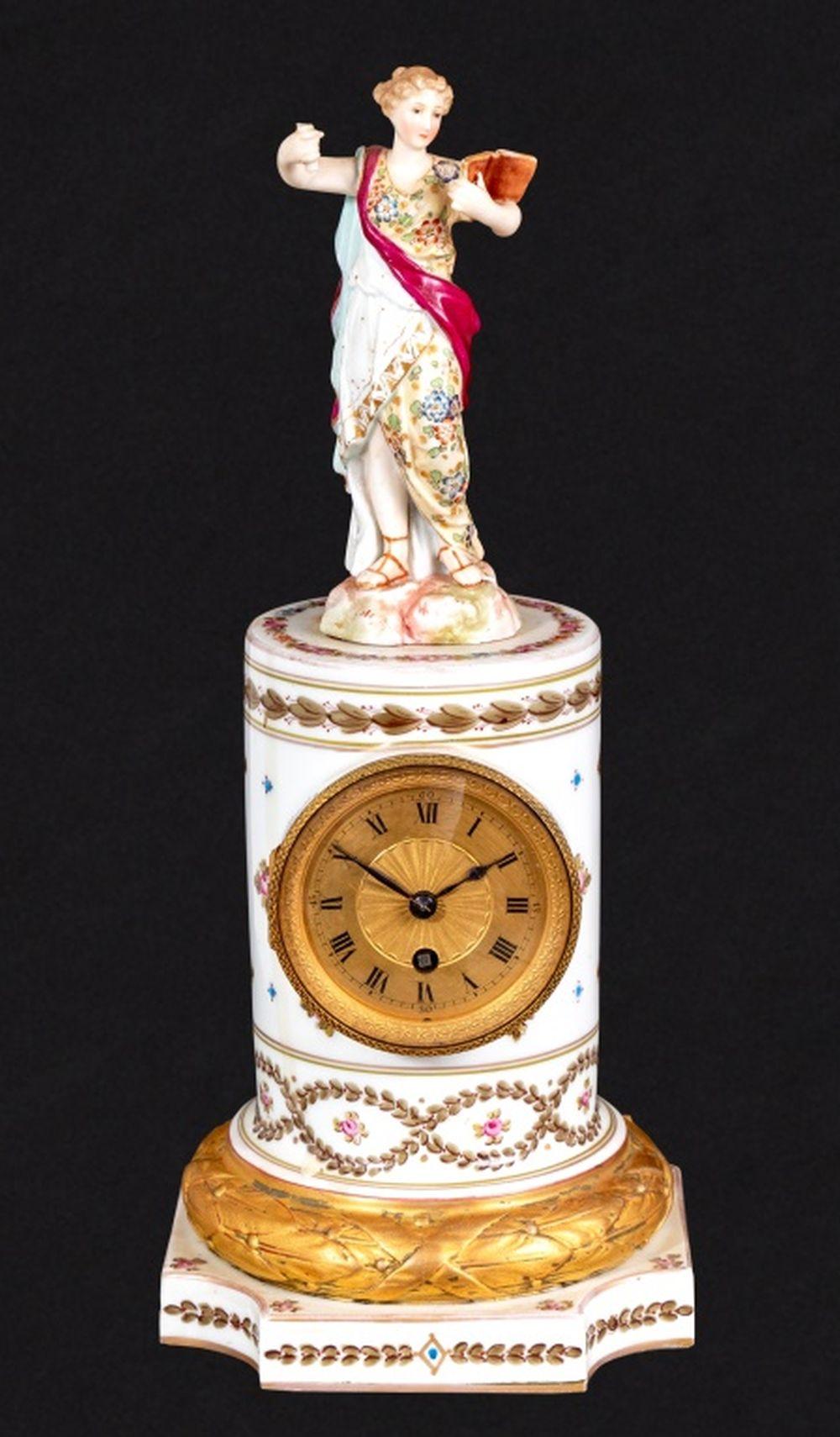 Louis XVI Style Sevres White Ground Figural Pedestal Clock, late 19th century, the brass circular dial, timepiece movement, on acanthus wreath base and square plinth, marked with crossed swords to interior, surmounted by an associated Sevres style