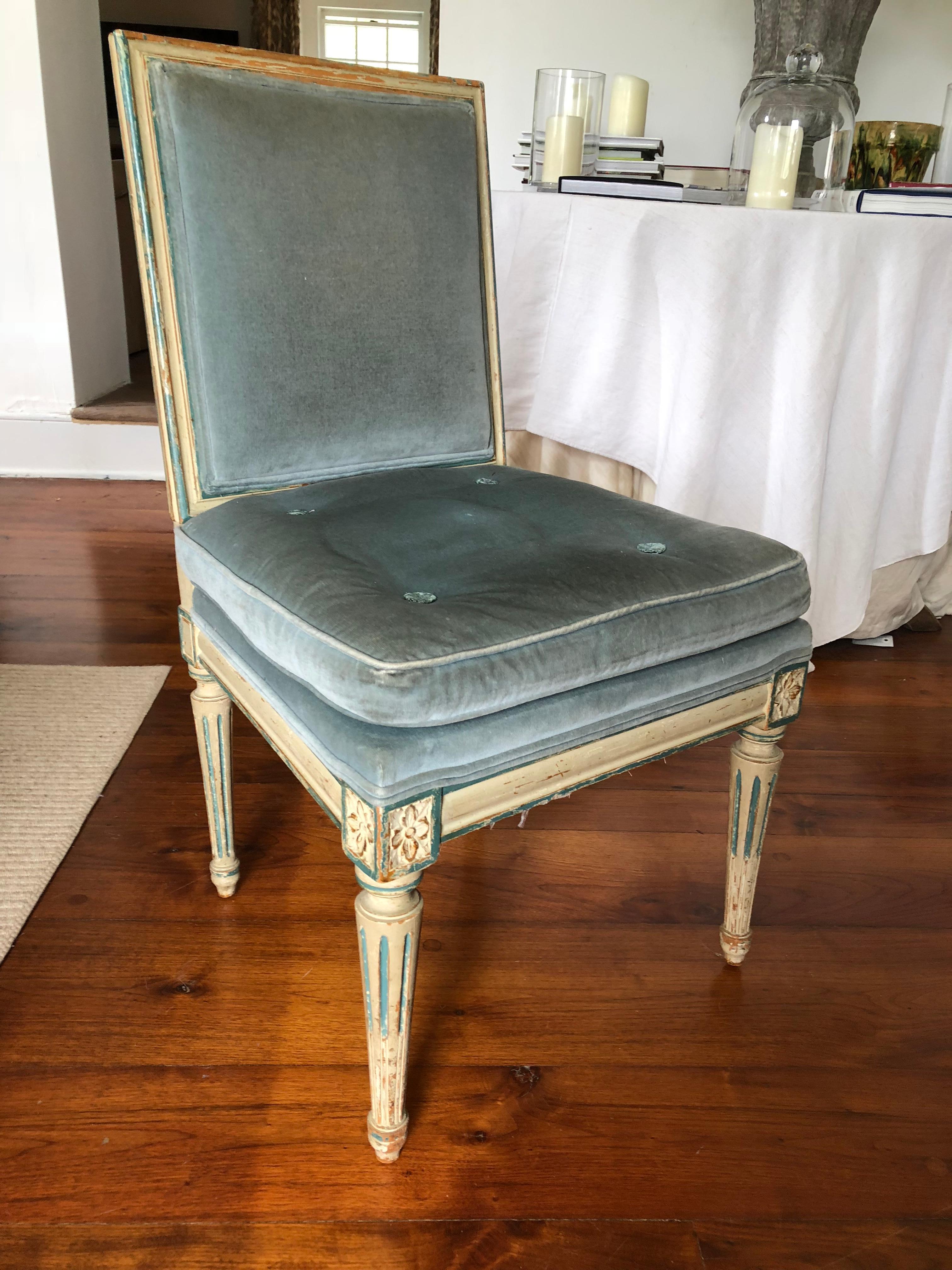 A French Louis XVI style side chair in old cream painted finish with blue trim, upholstered in old light blue velvet, circa 1890, with tapered and fluted legs.