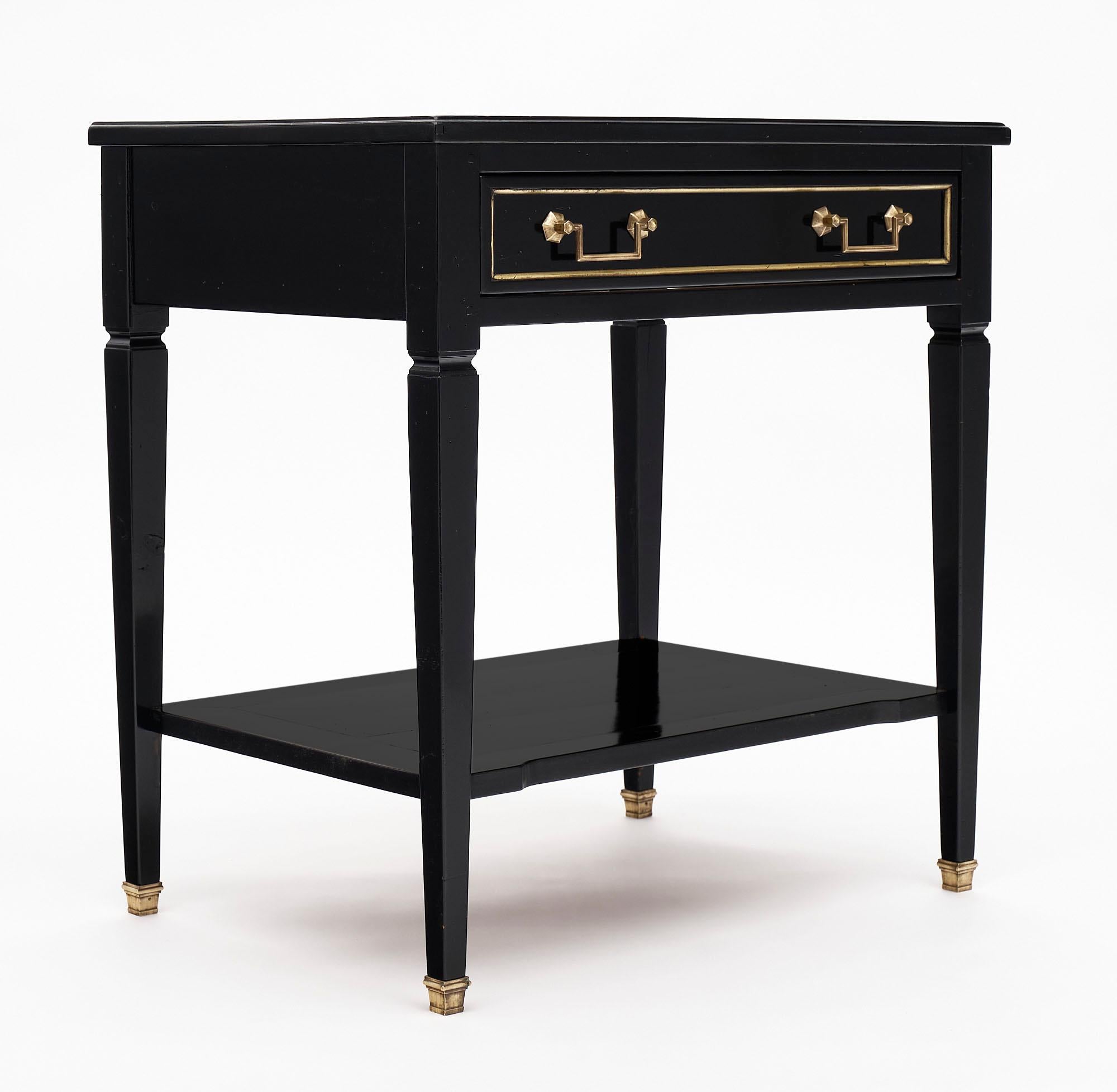 Louis XVI style side table or console made of solid cherry wood that has been finished with an ebony lustrous French polish. There is one dovetailed drawer with bronze hardware and a lower shelf.