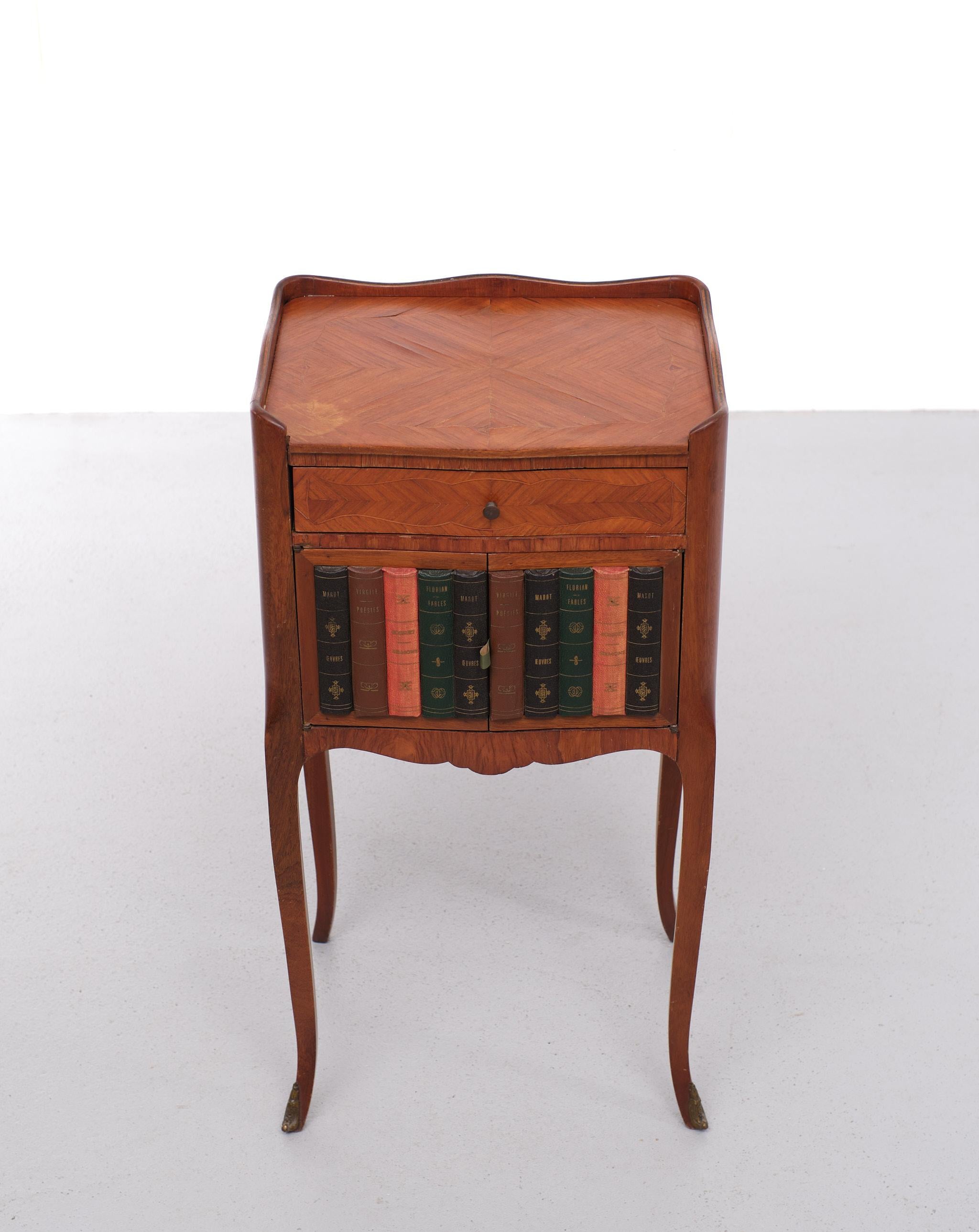 Very nice attractive classic side table. In a Louis xvi style. Nice inlay wood.
Bronze feet ,On the front doors Book-covers.