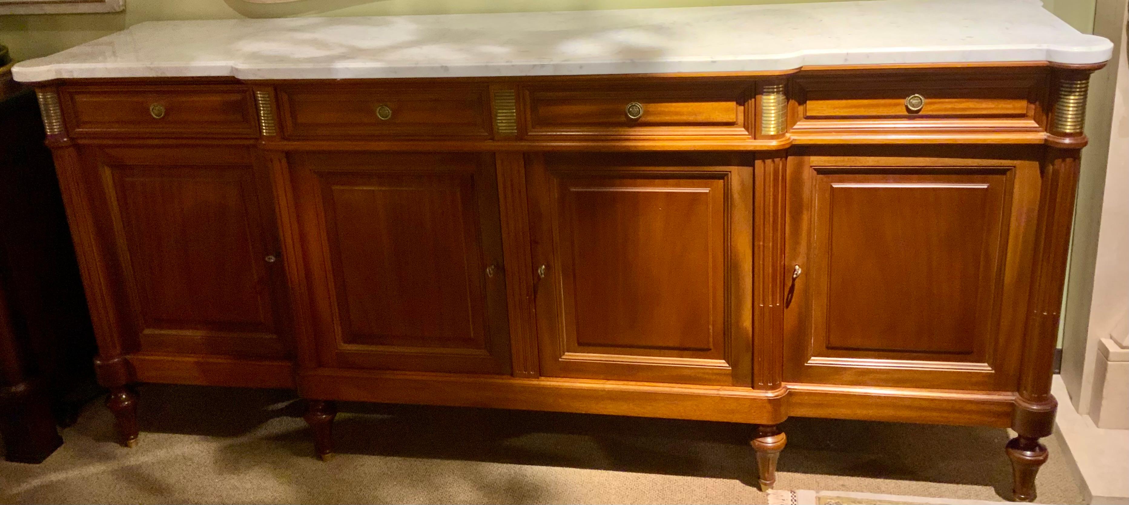 This piece has beautiful and simple lines. It is made of very
Fine mahogany and has a clean white marble with pale
Gray veining. It is in fine condition and has no flaws or
Problems with the finish. All drawers open easily and the
Doors open freely