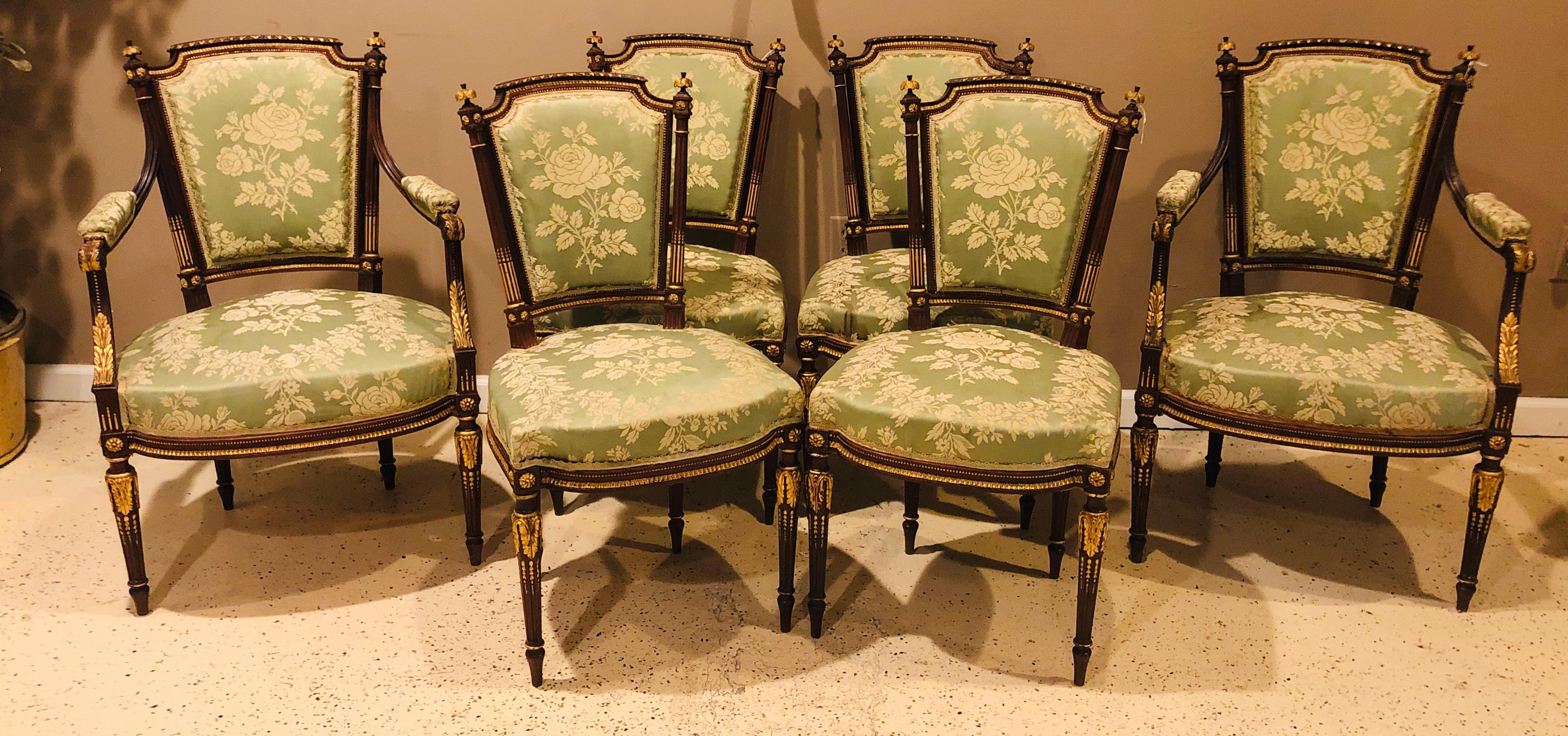Louis XVI style parcel-gilt mahogany six-piece parlor suite comprising a pair of arm and four side chairs in celery damask silk upholstery. The pieces are all decorated with finely carved wood work. Can purchase all or part of the set as is