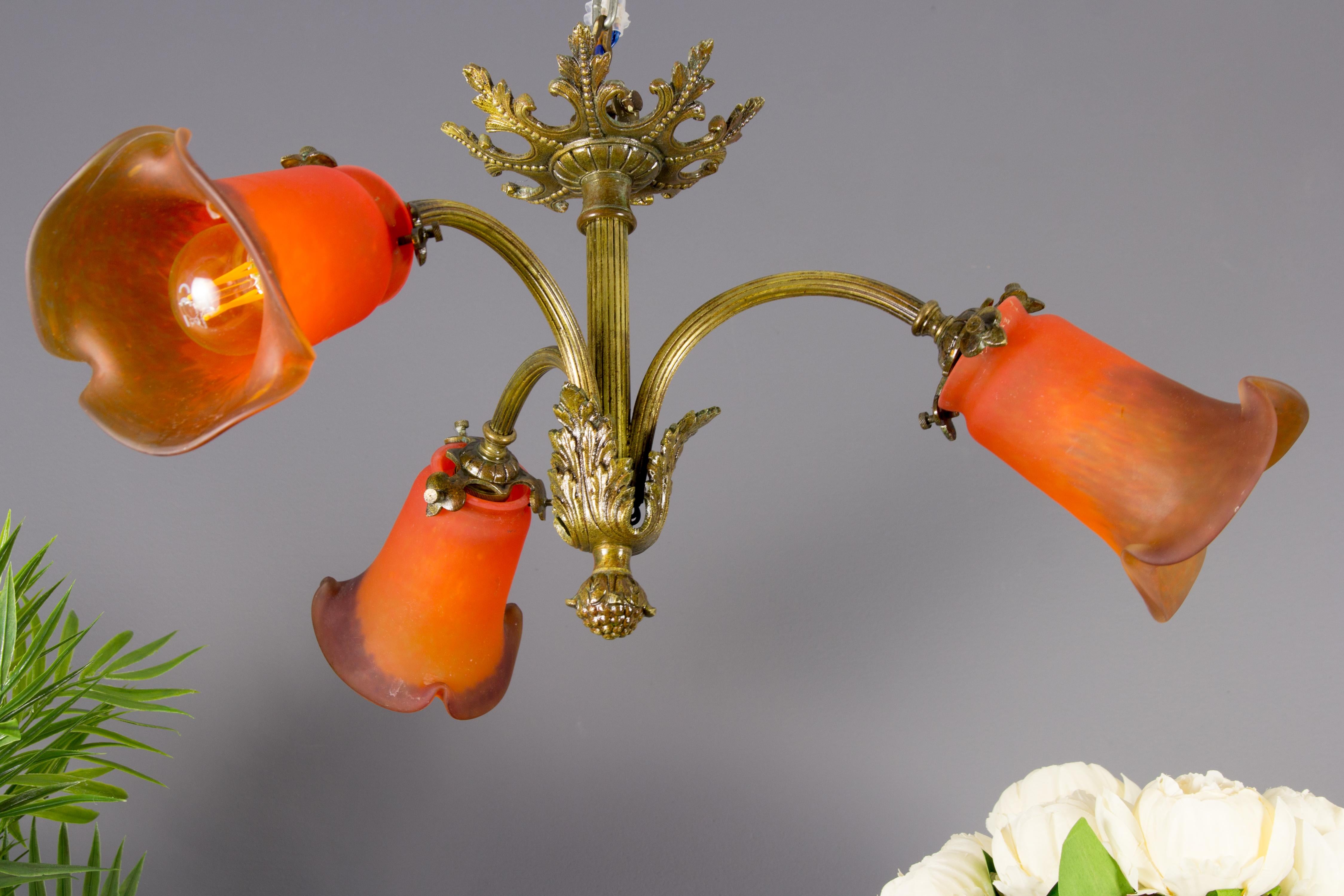 A Small but fine French Louis XVI-style chandelier. Three bronze branches, each with a red Pâte de Verre glass shade, socket for B22 size light bulb.
Dimensions: diameter 49 cm / 19.29 in; height 24 cm / 9.44 in.
The light fixture is in complete