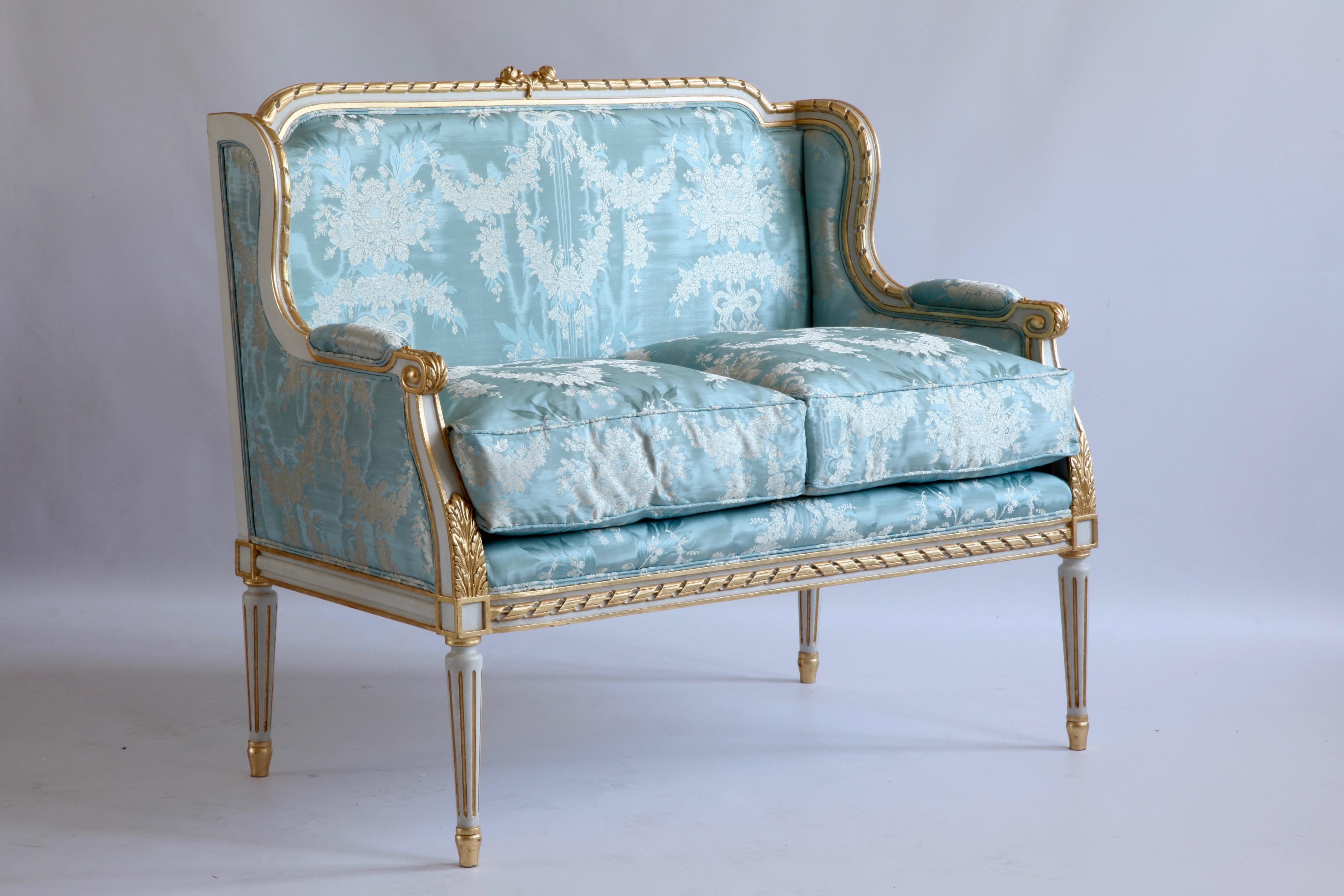 Louis XVI style canape made by La Maison London.
Hand carved in solid wood, painted in an ecru white with gold highlights.
Upholstered in a fabric of your choice 
Please note: 11m of fabric is required, this is not included in the price. We Have a