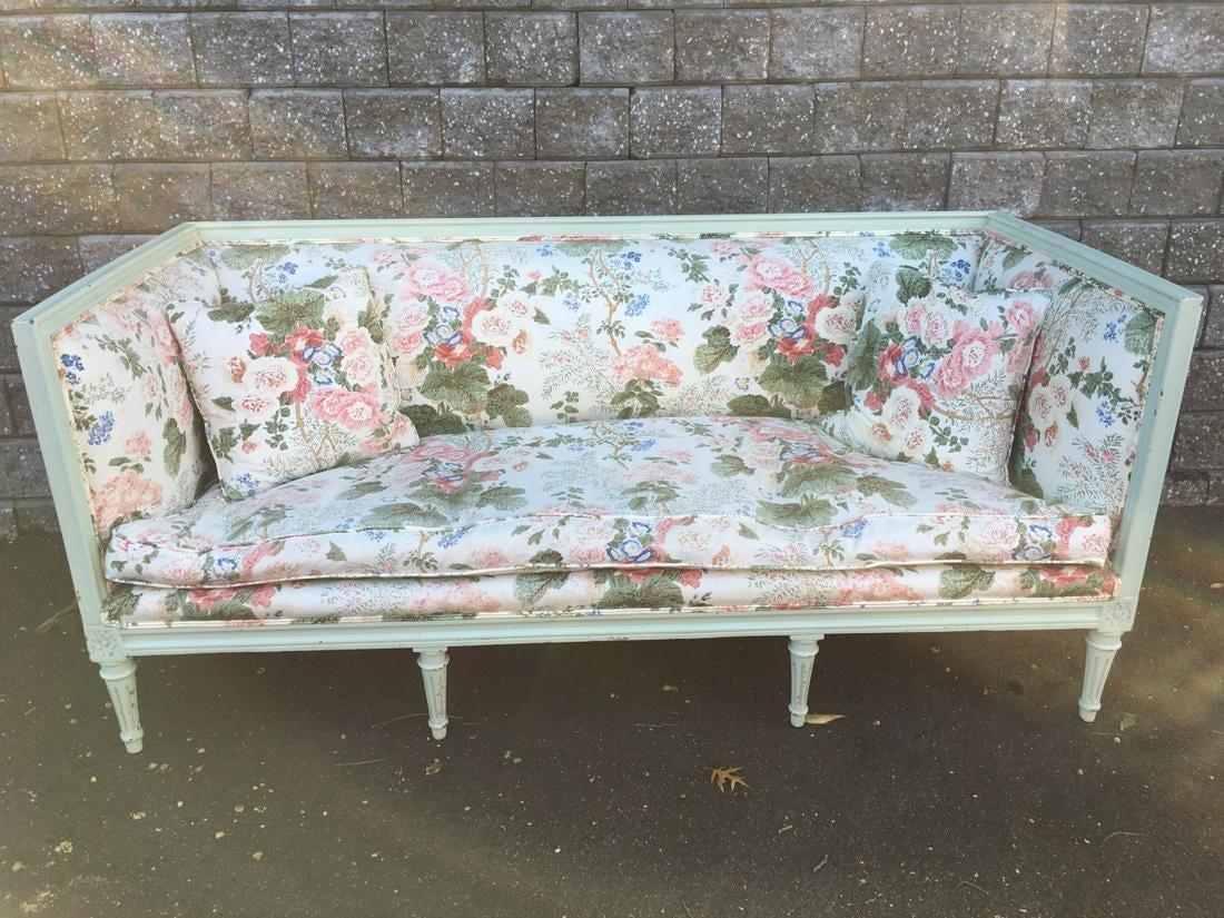French painted sofa/settee frame with high continuous square back and sides (arms), fluted Louis XVI legs. Upholstered shabby chic floral print. Suitable for Swedish Gustavian, neoclassical, shabby chic or modern settings.